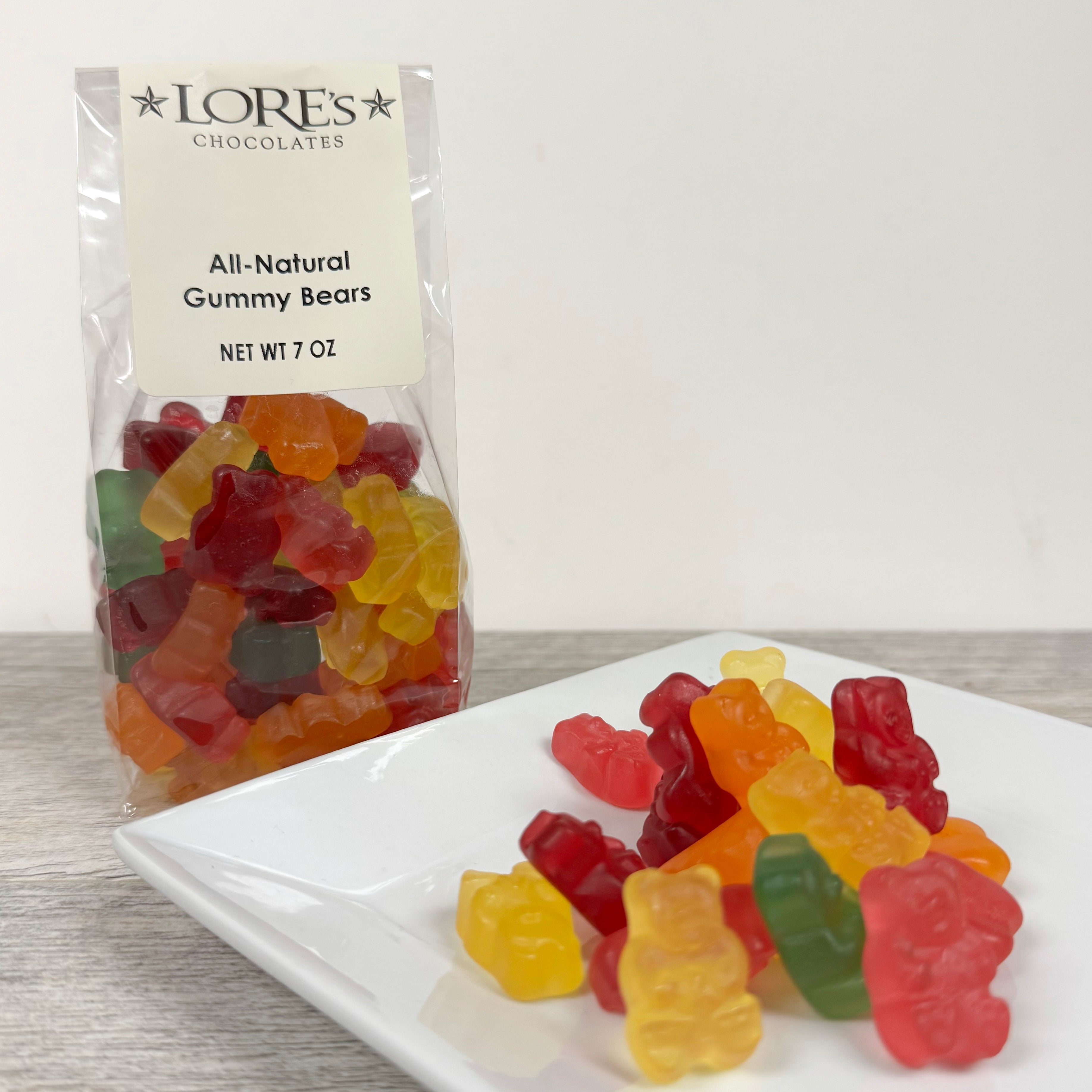 Packaged all-natural gummy bears with a LORE'S CHOCOLATES label on a white surface.