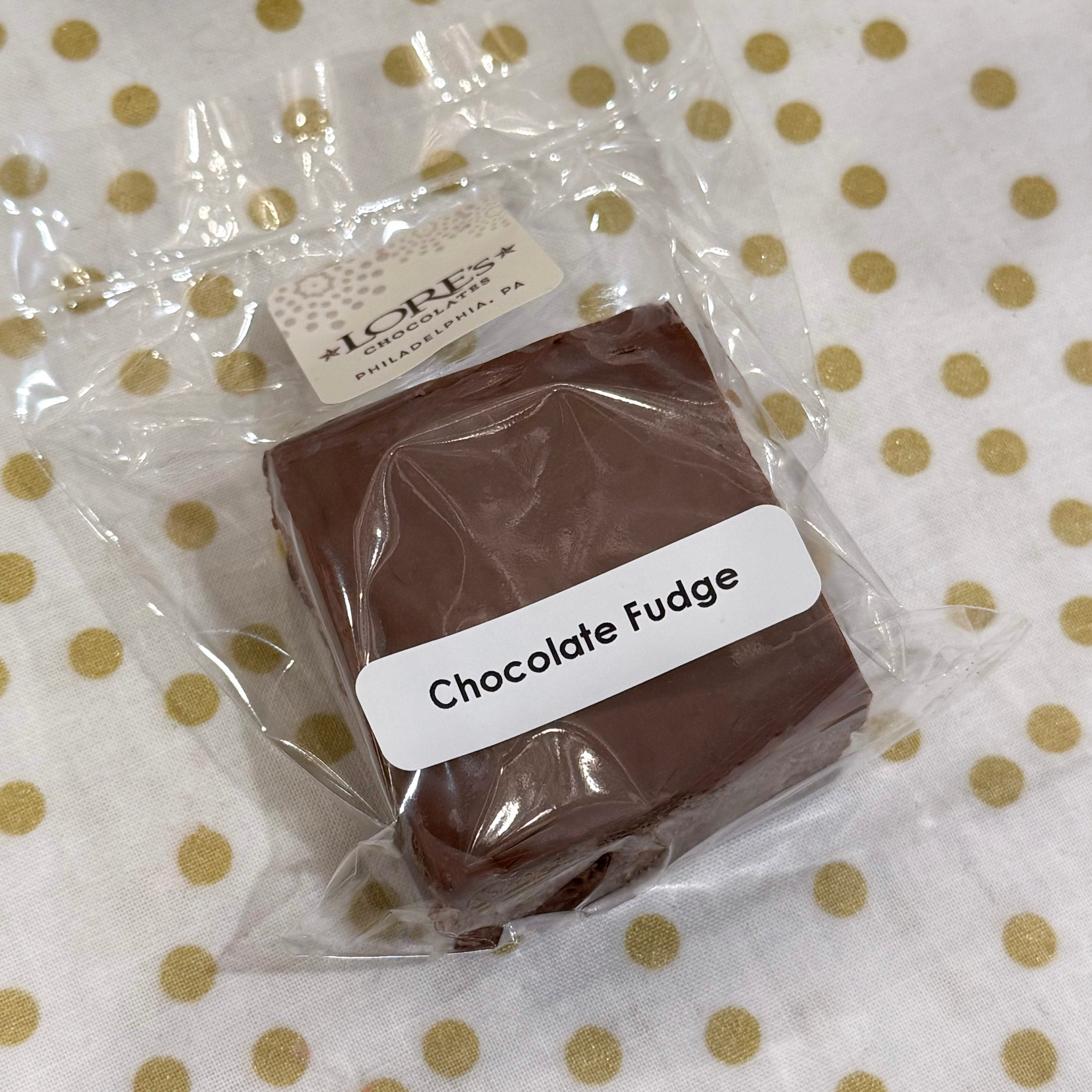 Packaged chocolate fudge with a label on a polka-dot background - handmade by Lore's Chocolates in Philadelphia