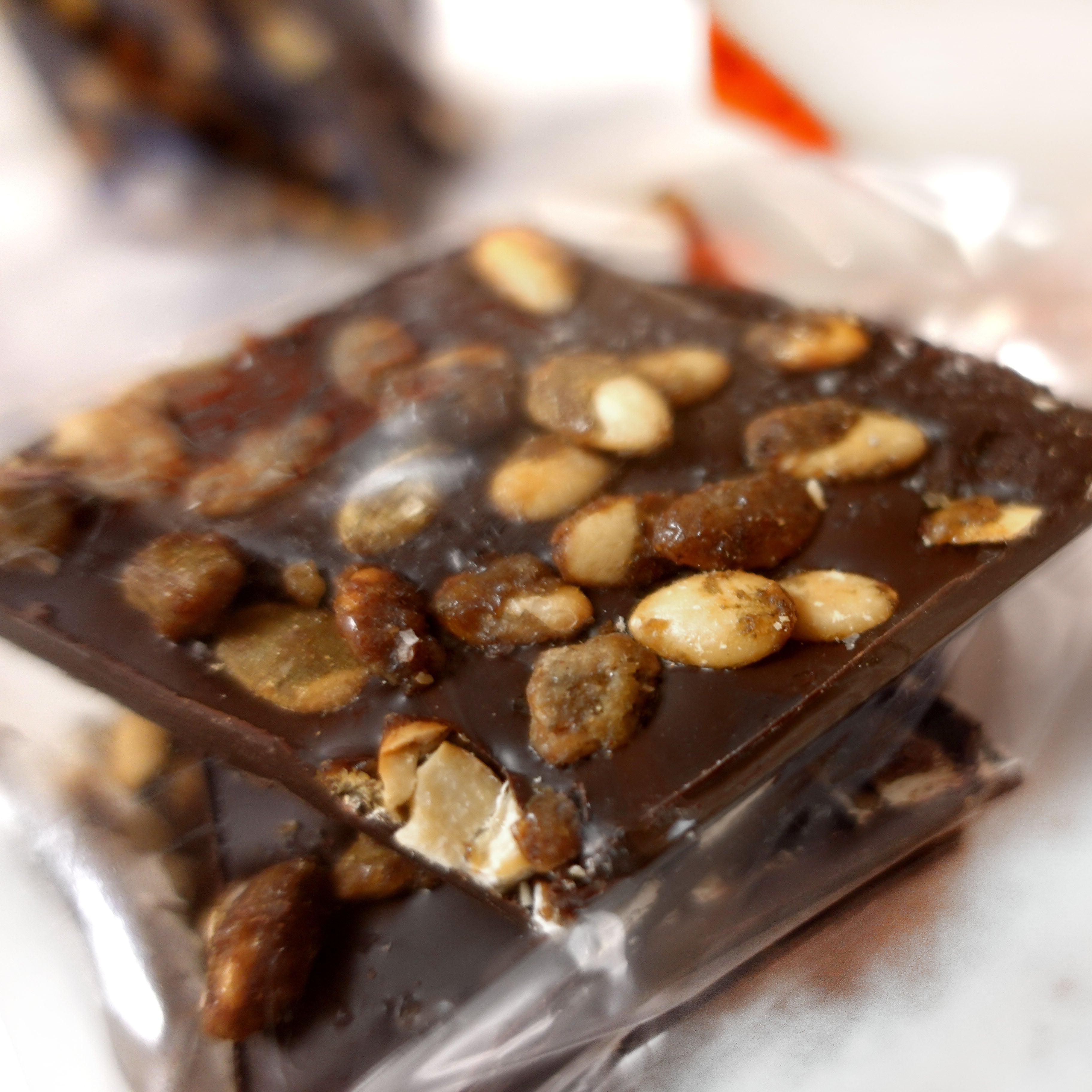 Close up detail of toasted spiced pumpkin seeds in Lore's Dark Chocolate