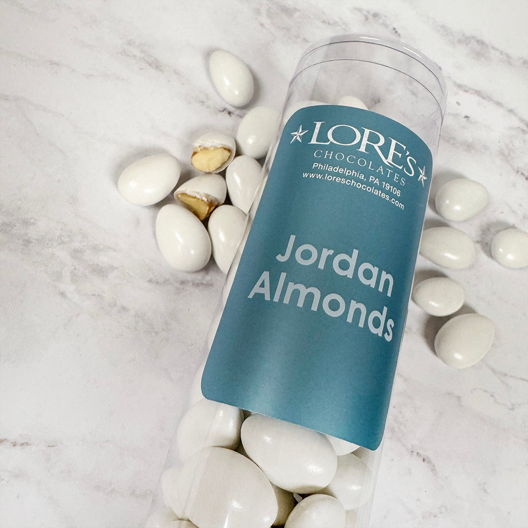 Jar of LORES Chocolates Jordan Almonds on a marble surface
