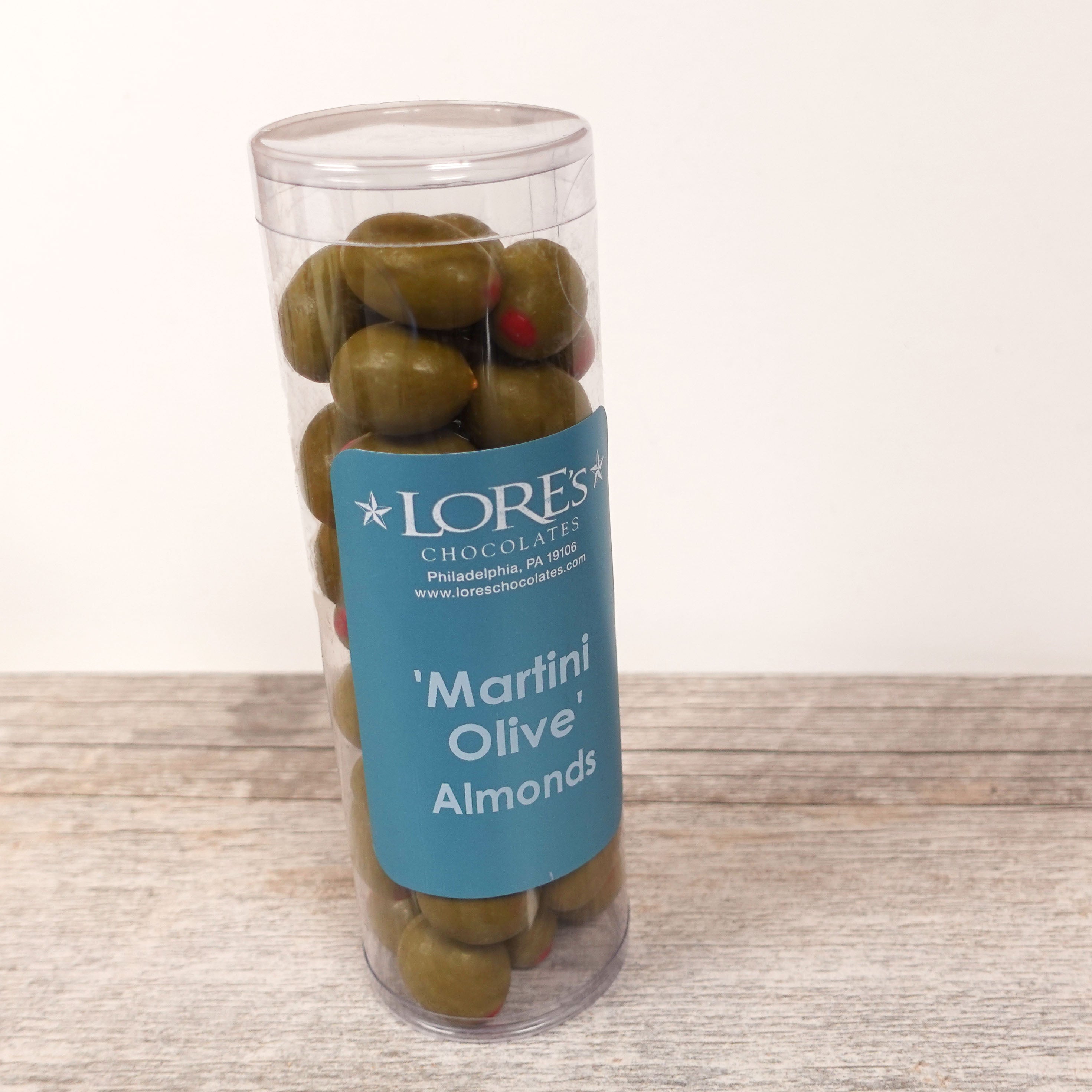 packaging container of White Chocolate Almonds that look like martini olives. Label reads: Lore's Chocolates Philadelphia PA 19106 (lore's website), Martini Olive Almonds