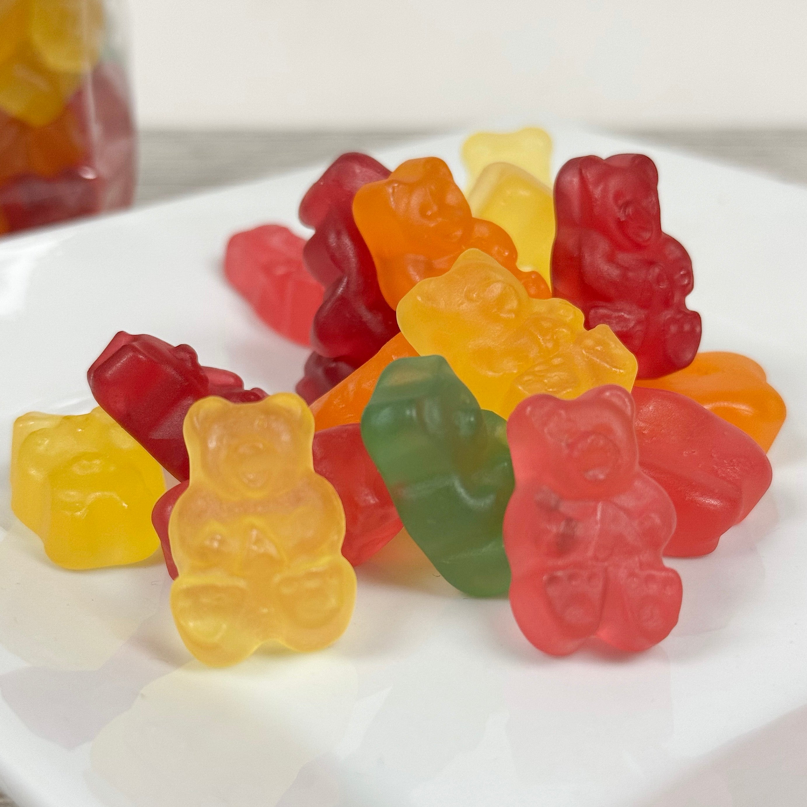 Colorful gummy bear candies on a white plate