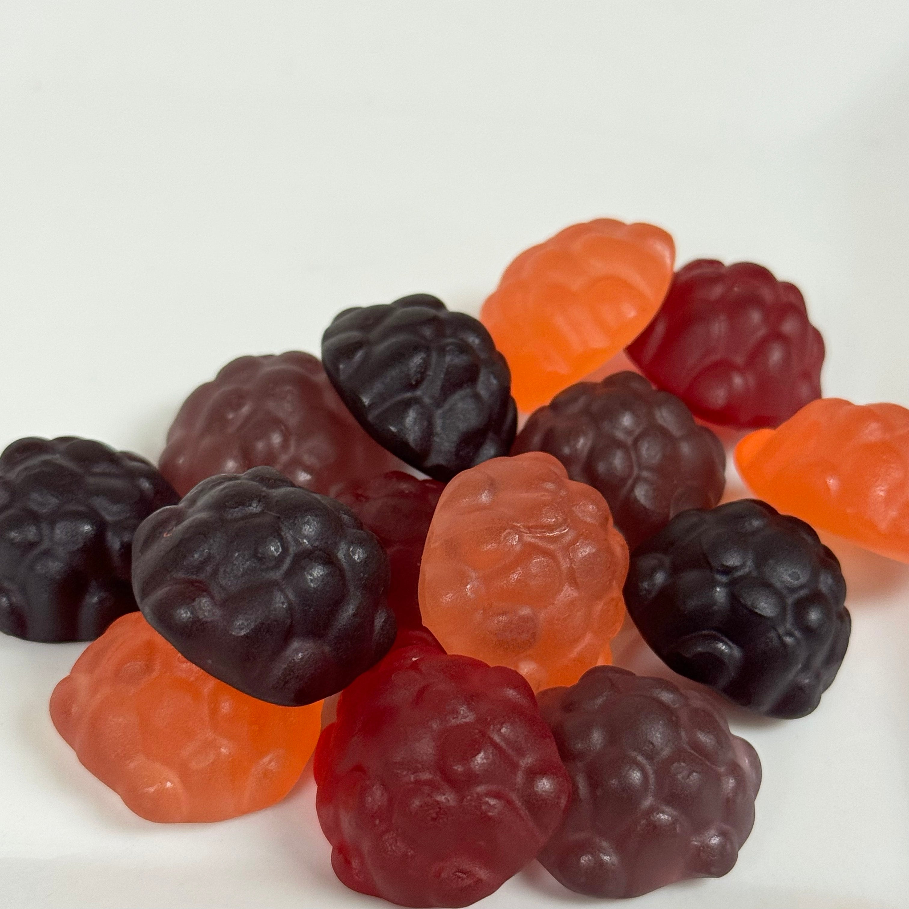 Assorted gummy berries including blackberries, grape, and strawberries, on a white background. Sold at Lore's Chocolates in Philadelphia