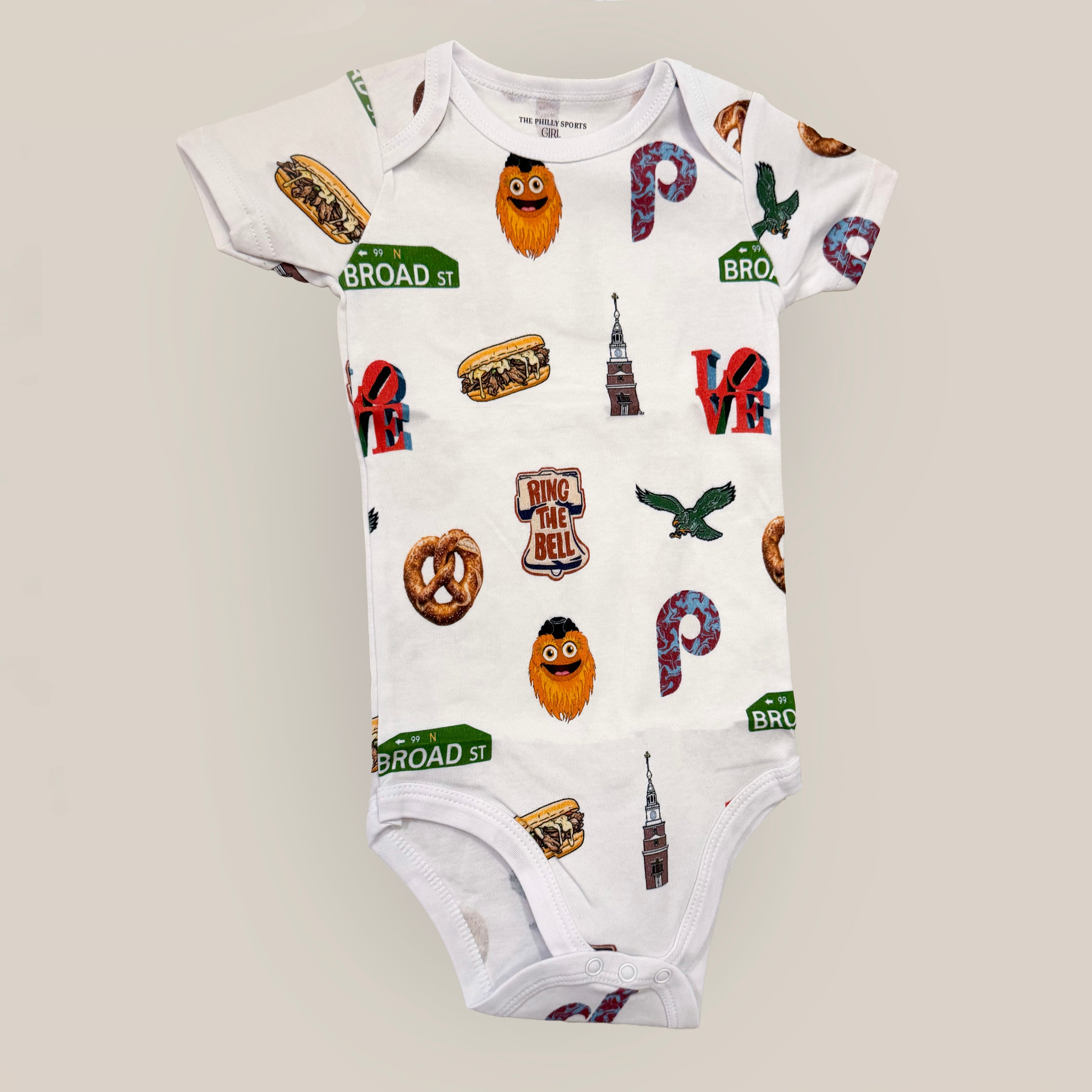 Baby onesie with colorful philly graphics on a light gray background, sold in philadelphia at lore's chocolates