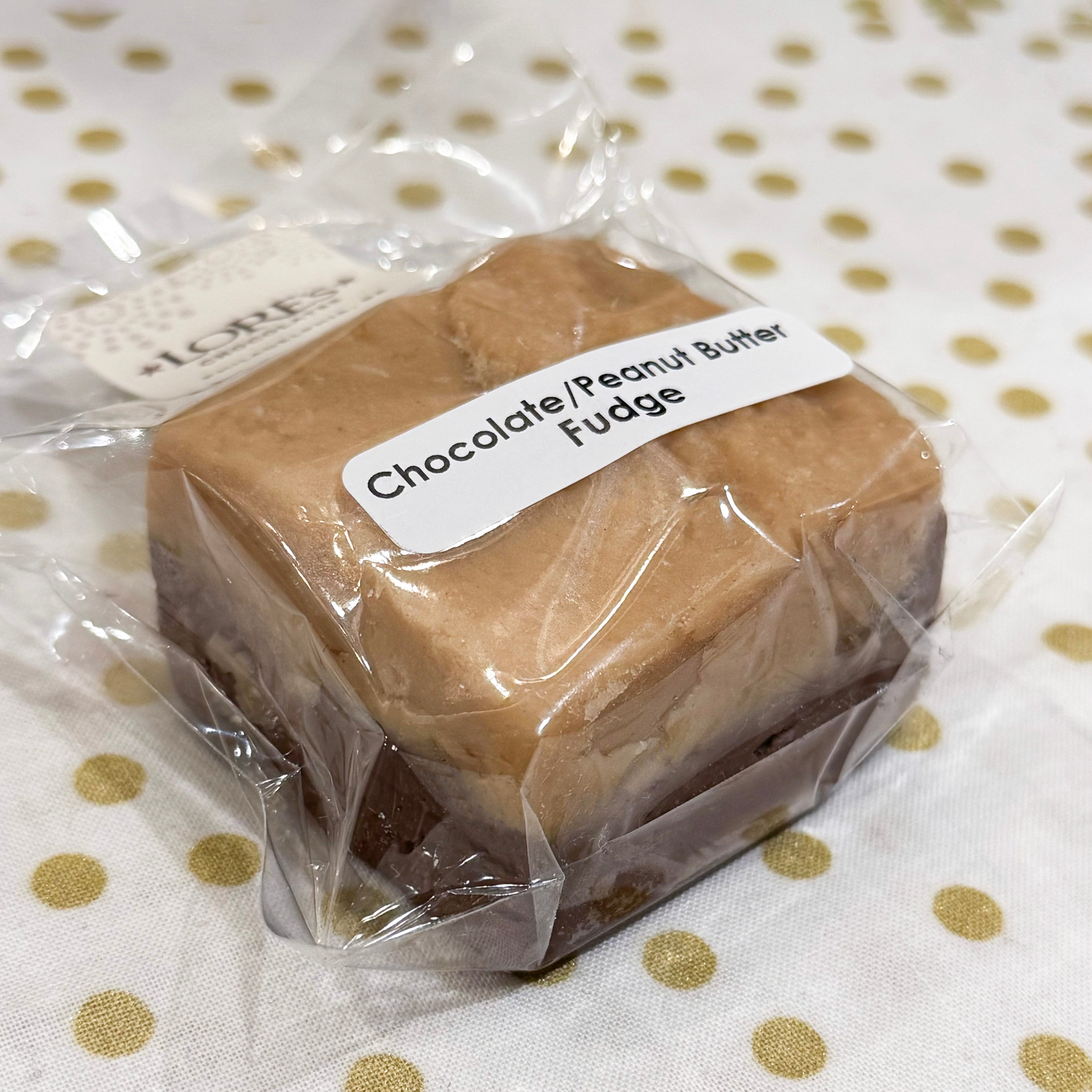 Block of chocolate peanut butter fudge in clear packaging with a label on a polka dot background - handmade by Lore's Chocolates in Philadelphia