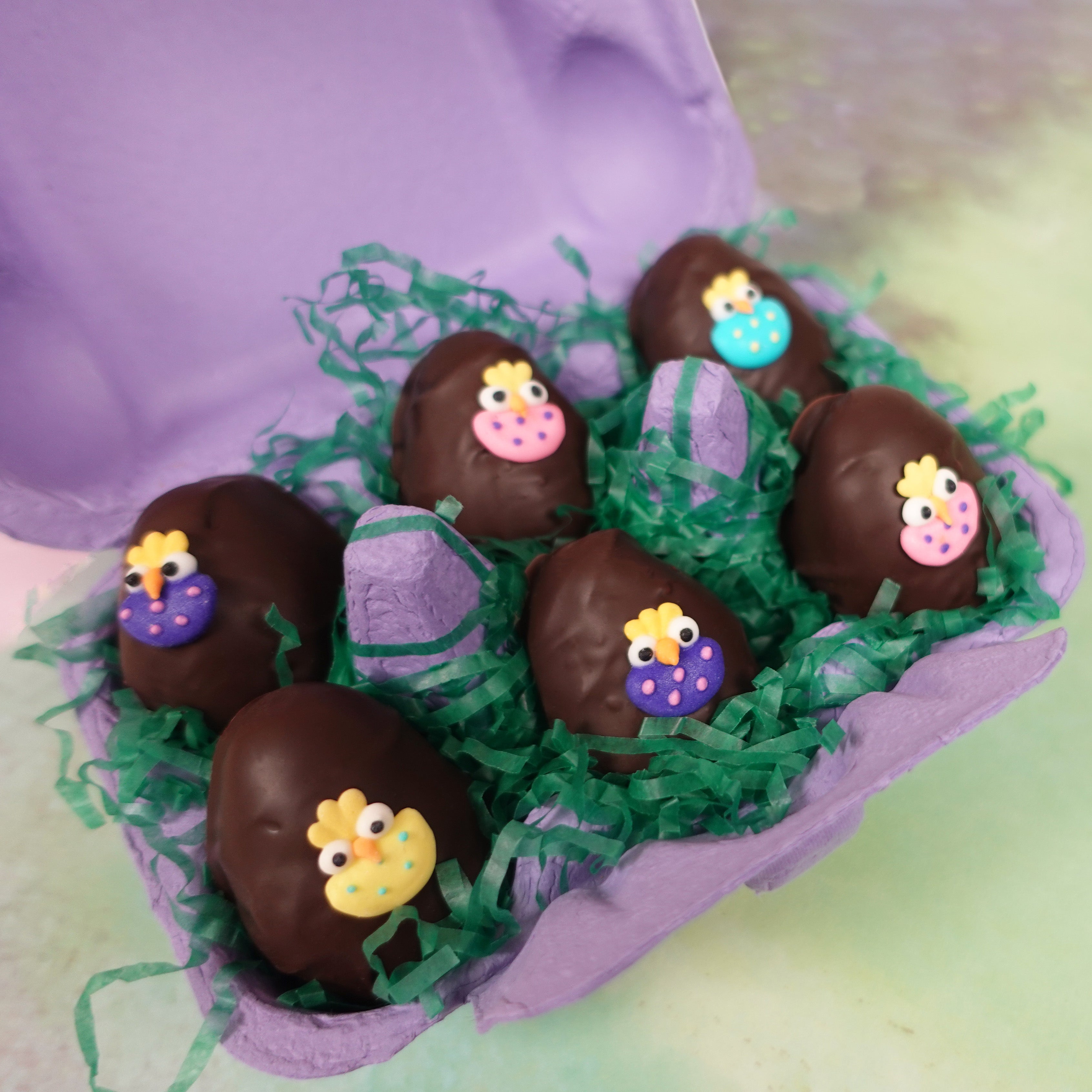 purple carton of dark chocolate coconut cream eggs with assorted easter chick decorations