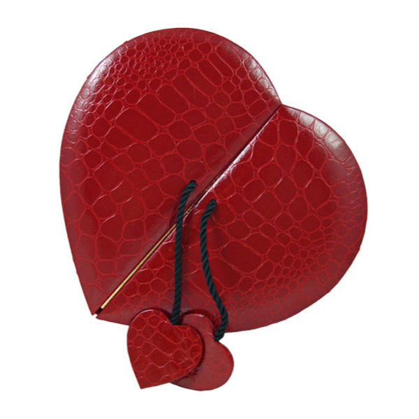 Heart shaped box with a crocodile/alligator leather pattern, opens in the middle with black cord with small alligator heart on either door. (Contains Artisan Truffles from Lore's Chocolates)