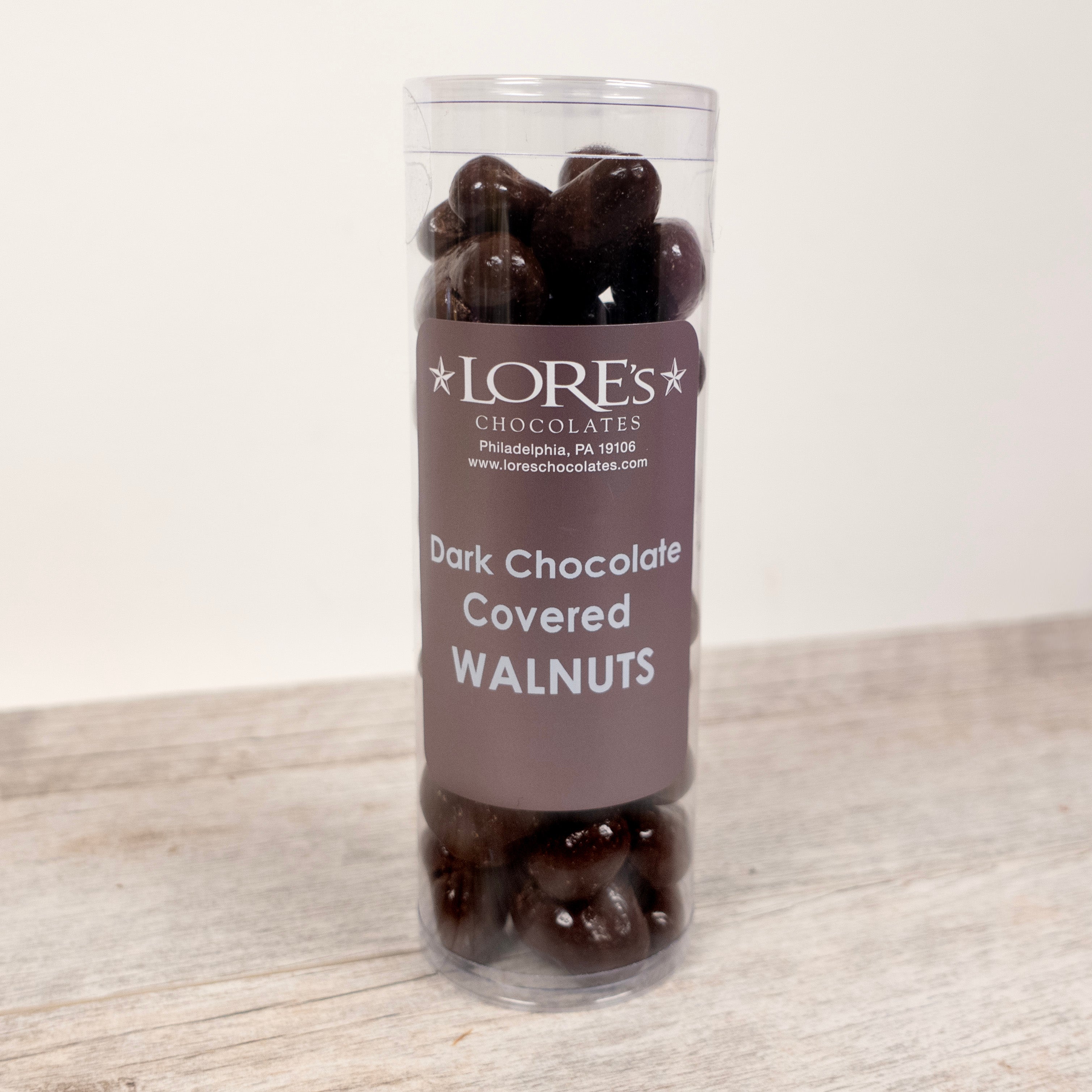 "Dark Chocolate Covered Walnuts" "Lore's Chocolates, Philadelphia, PA 19106" packaged in a clear cylinder
