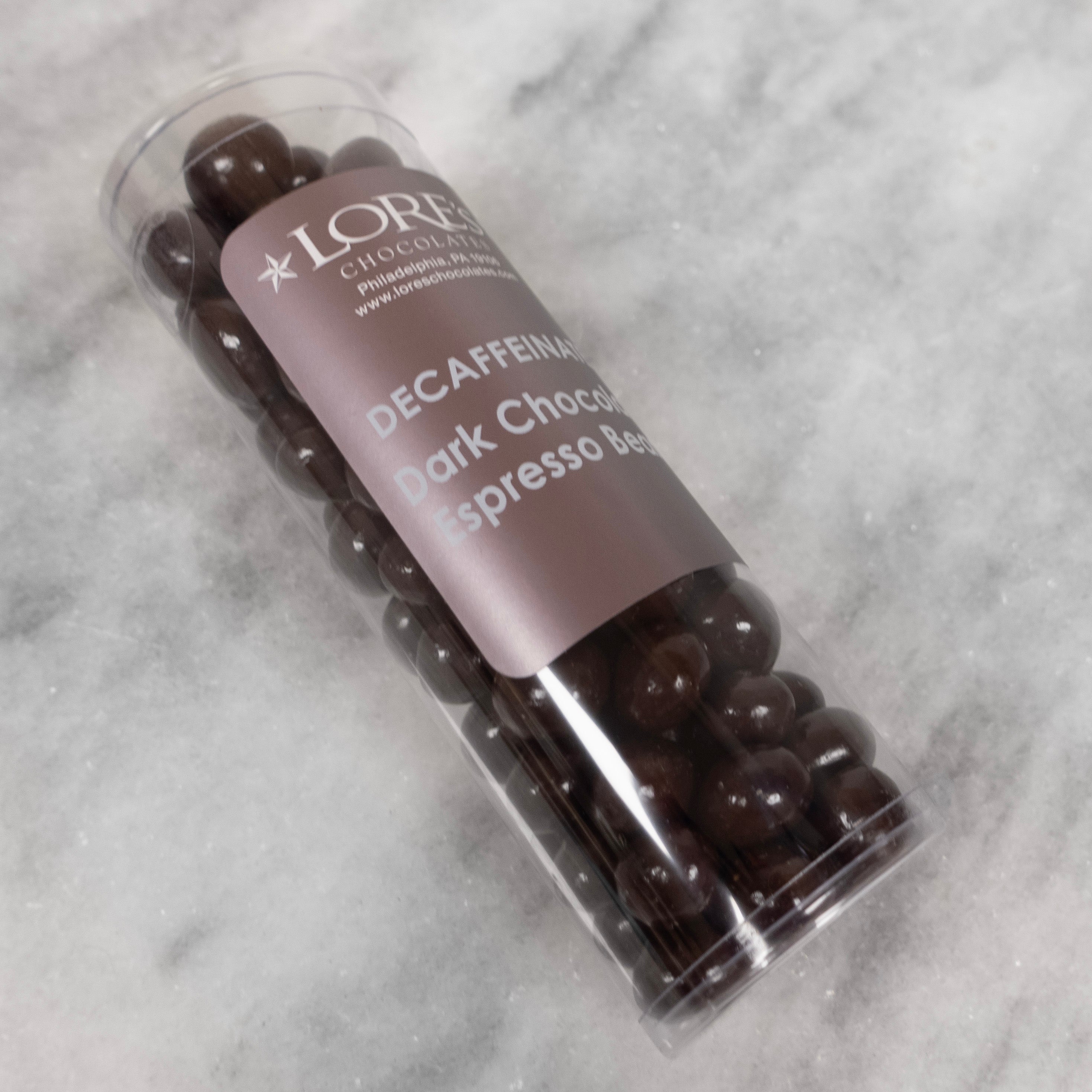 Dark Chocolate espresso beans - Decaffeinated in a clear cylinder tube container from Lore's Chocolates in Philadelphia PA