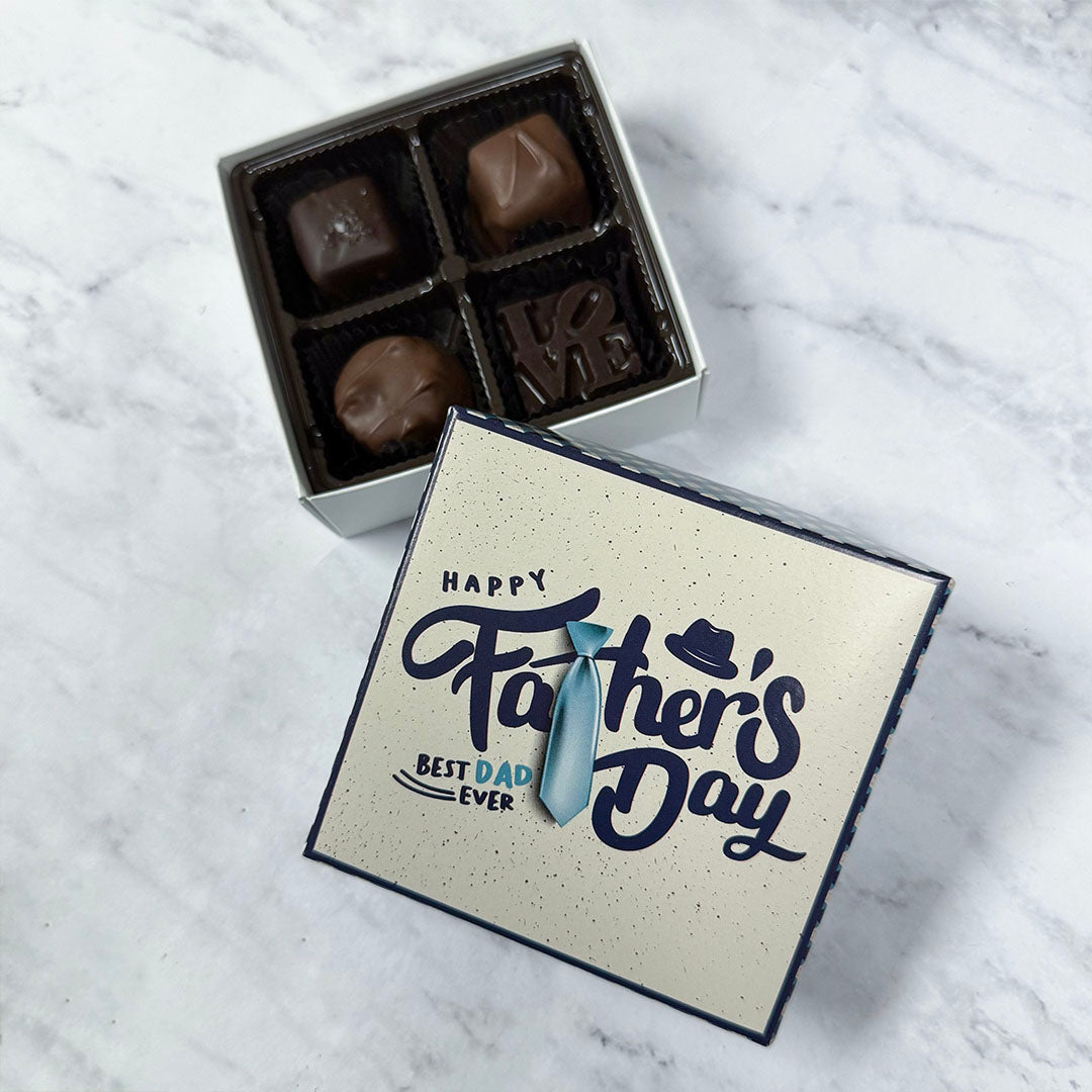 Box of 4 chocolates with a 'Happy Father's Day Best Dad Ever' gift box on a marble surface