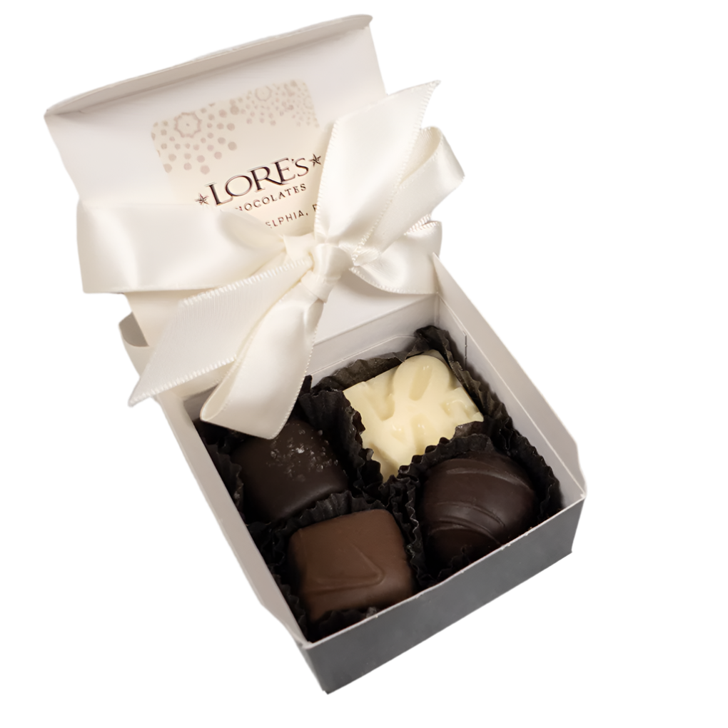 open gift box 4 piece assortment with caramels, solid chocolate, and a truffle. Lore's Chocolates Philadelphia, PA