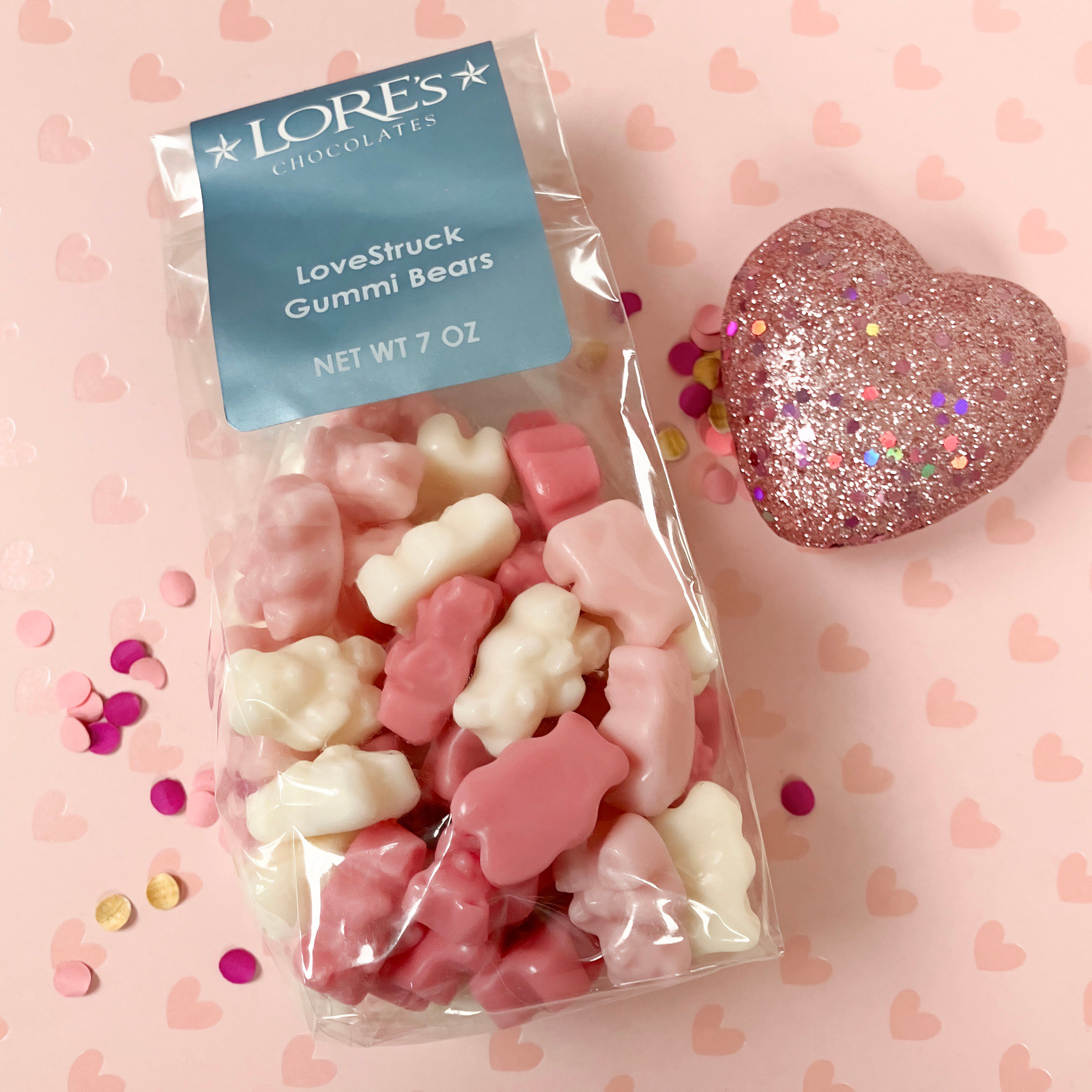 Packaged LORE's chocolates LoveStruck Gummi Bears on a pink heart patterned background