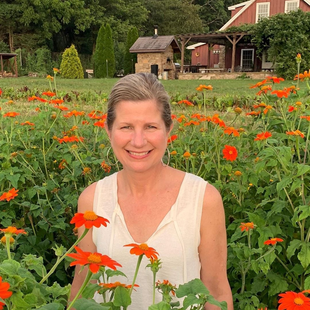 Maureen Walter in a field of orange flowers
