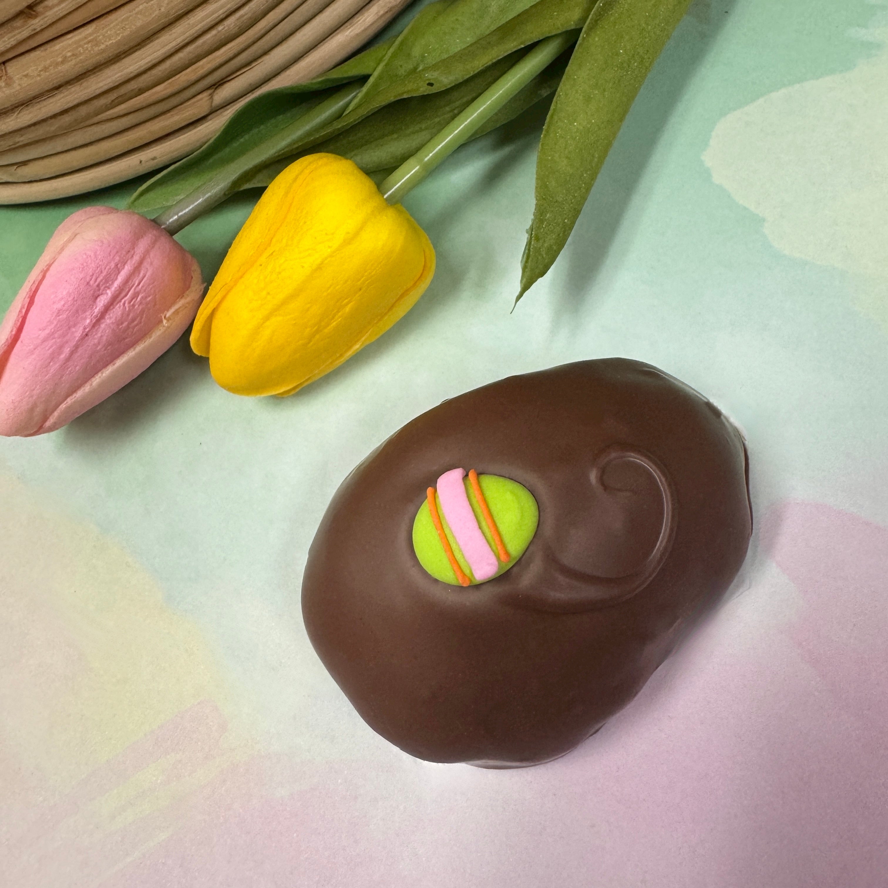 milk chocolate handmade easter egg with little green egg sugar decoration