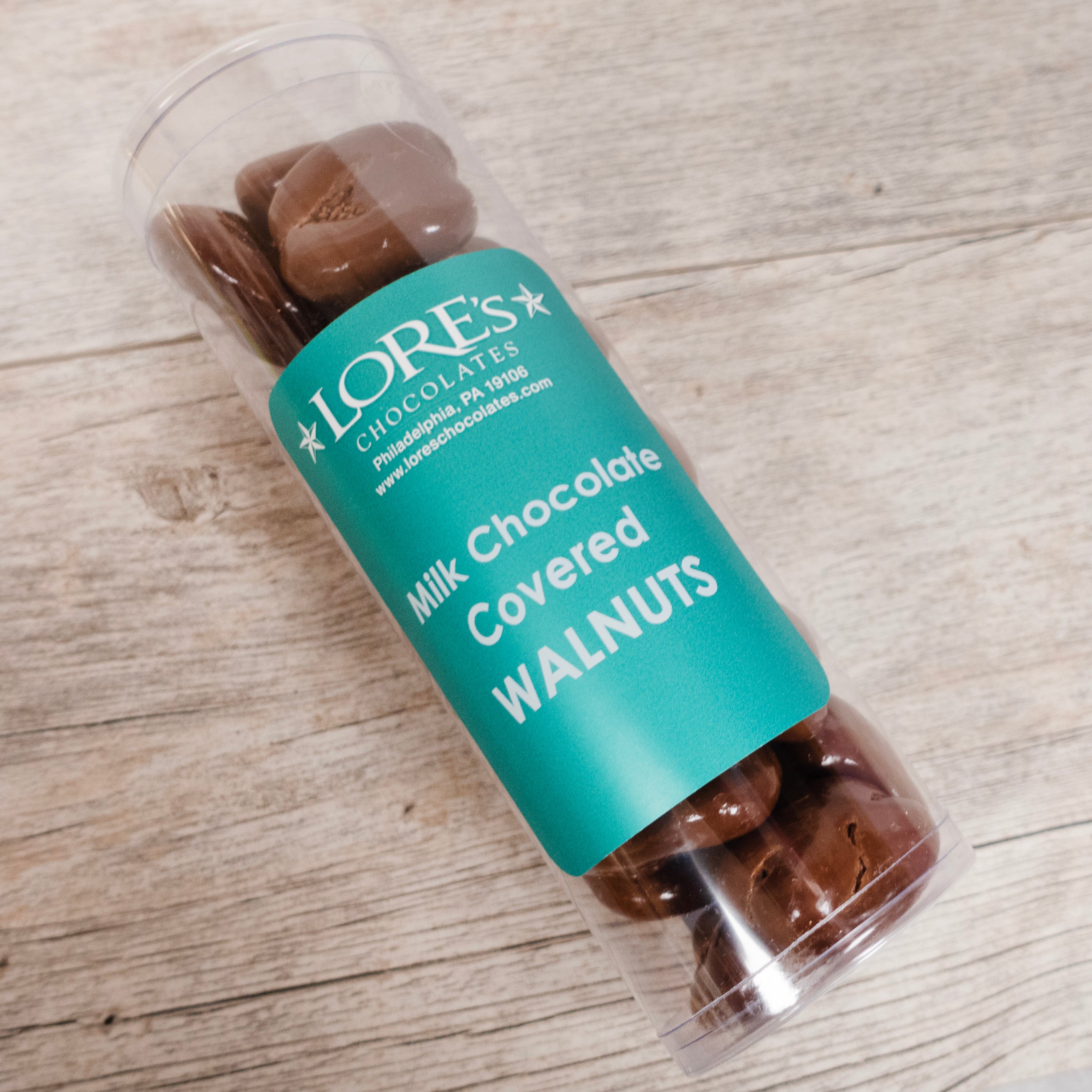 Cylinder container of "Milk Chocolate Covered Walnuts" sold at "Lore's Chocolates, Philadelphia PA 19016"