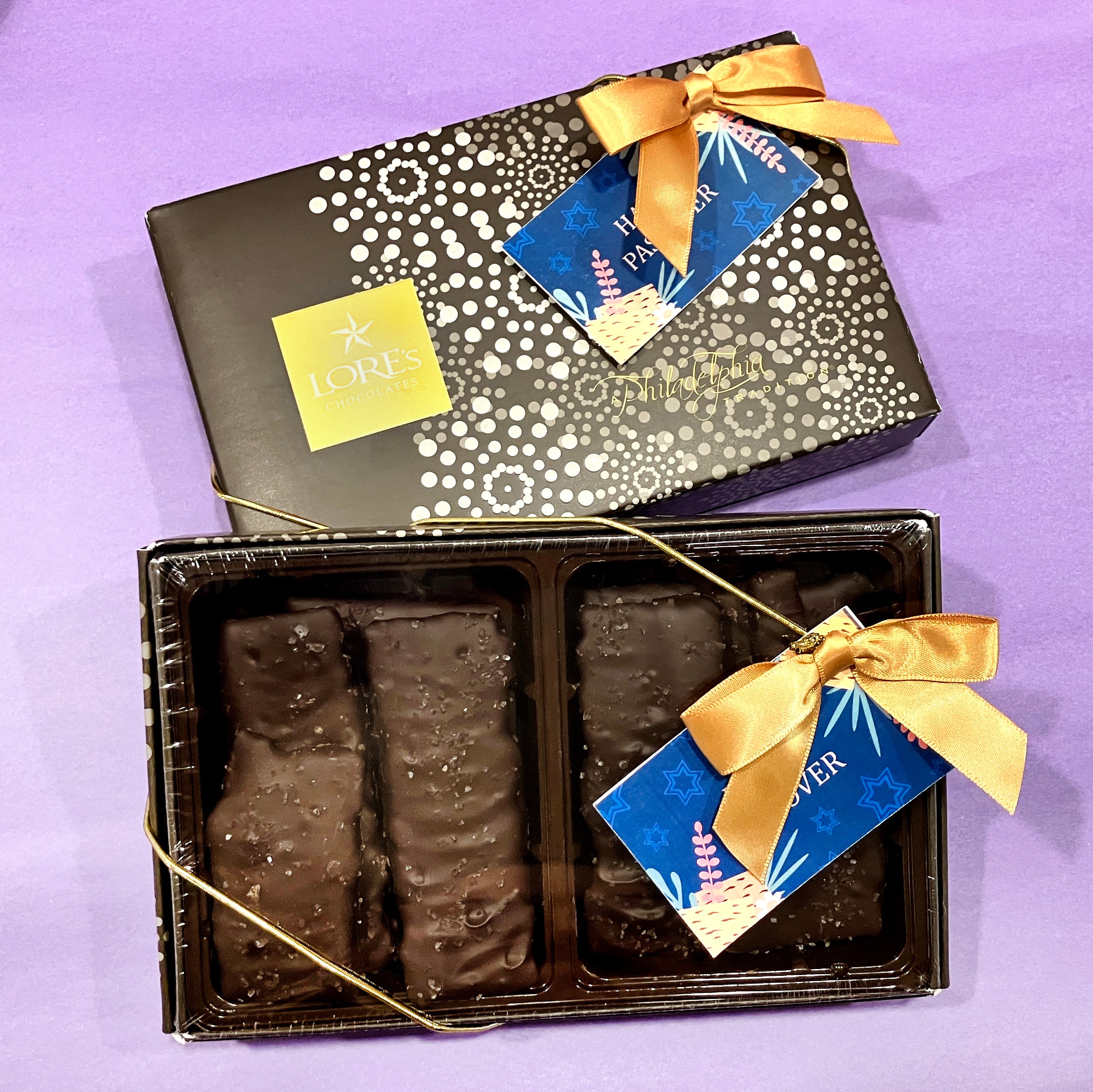 dark chocolate matzo in lore's chocolate's decorative box - hang tag reads "happy passover"