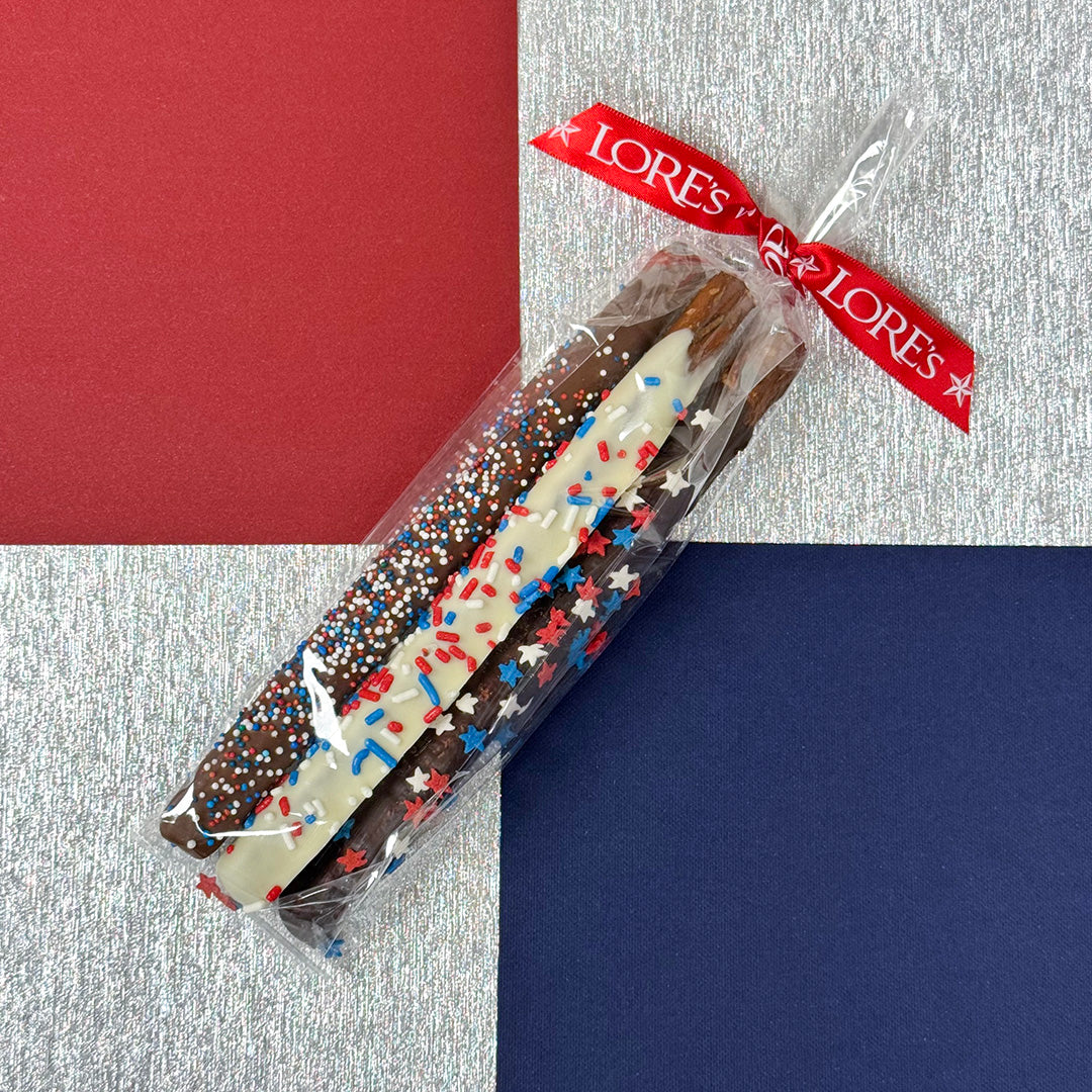 Packaged chocolate-dipped pretzels with a LORES branded ribbon on a multicolored background