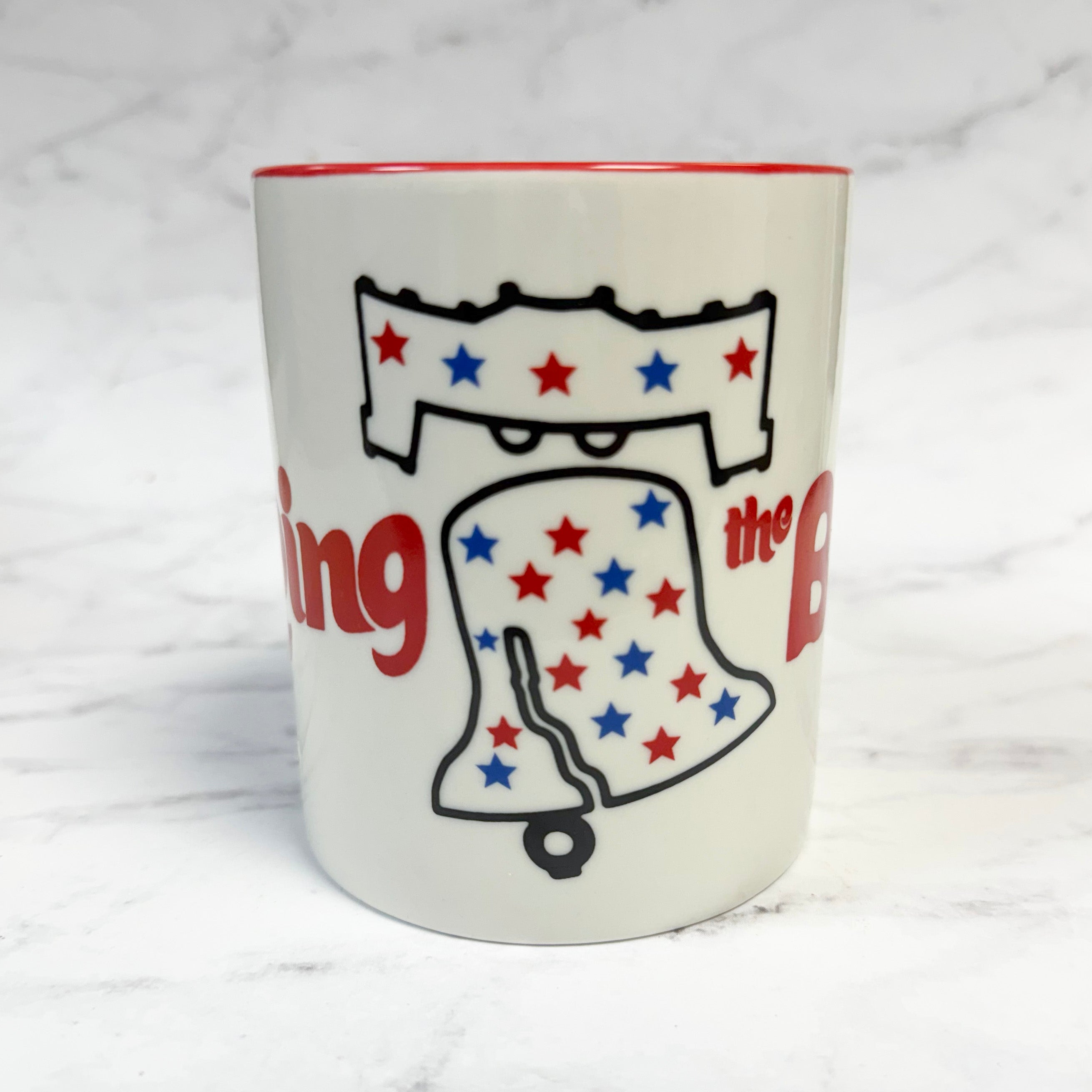 ring the bell - White mug with red interior, patriotic design of a liberty bell with stars, and text on a white background.