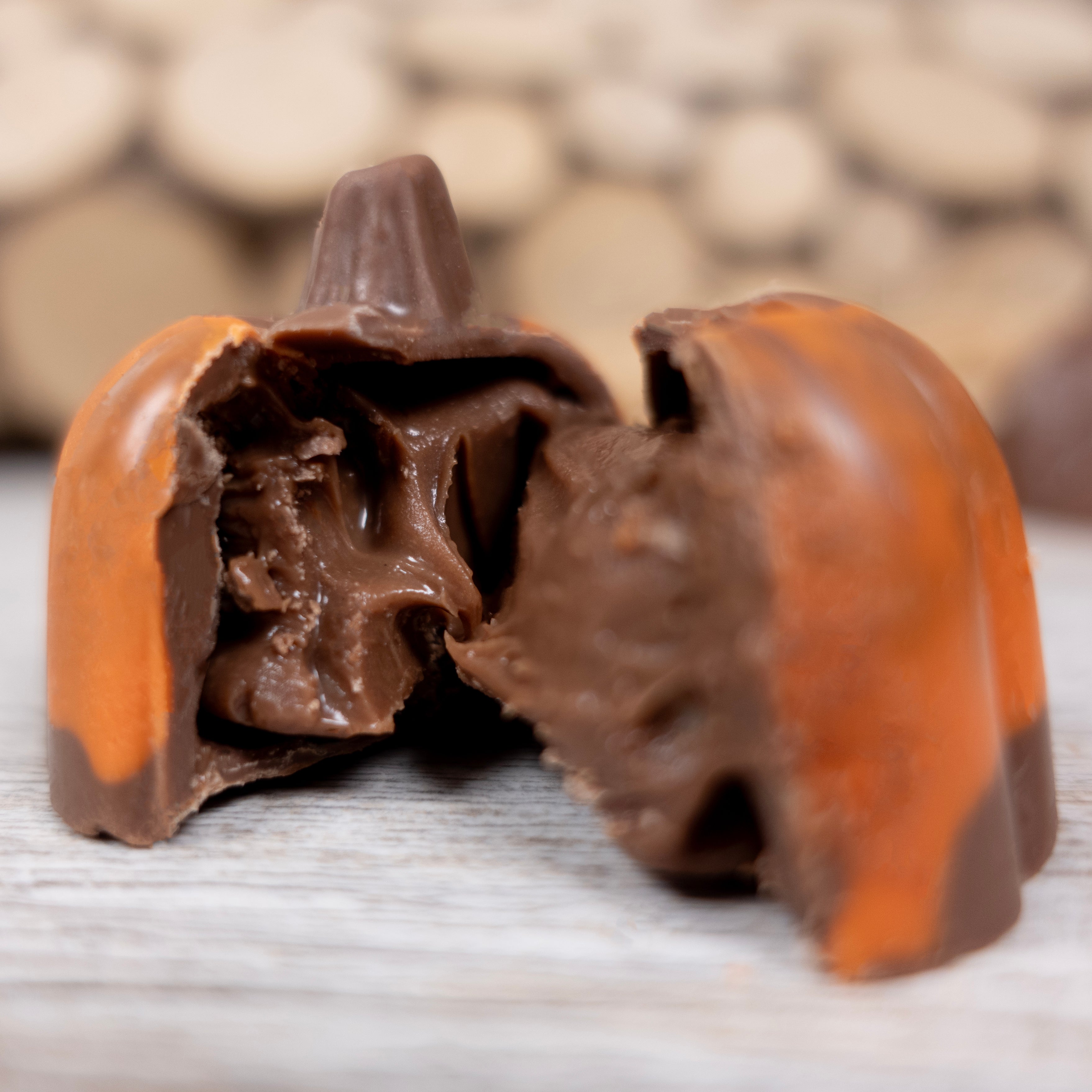 Close-up of a chocolate pumpkin spice truffle candy on a wooden surface
