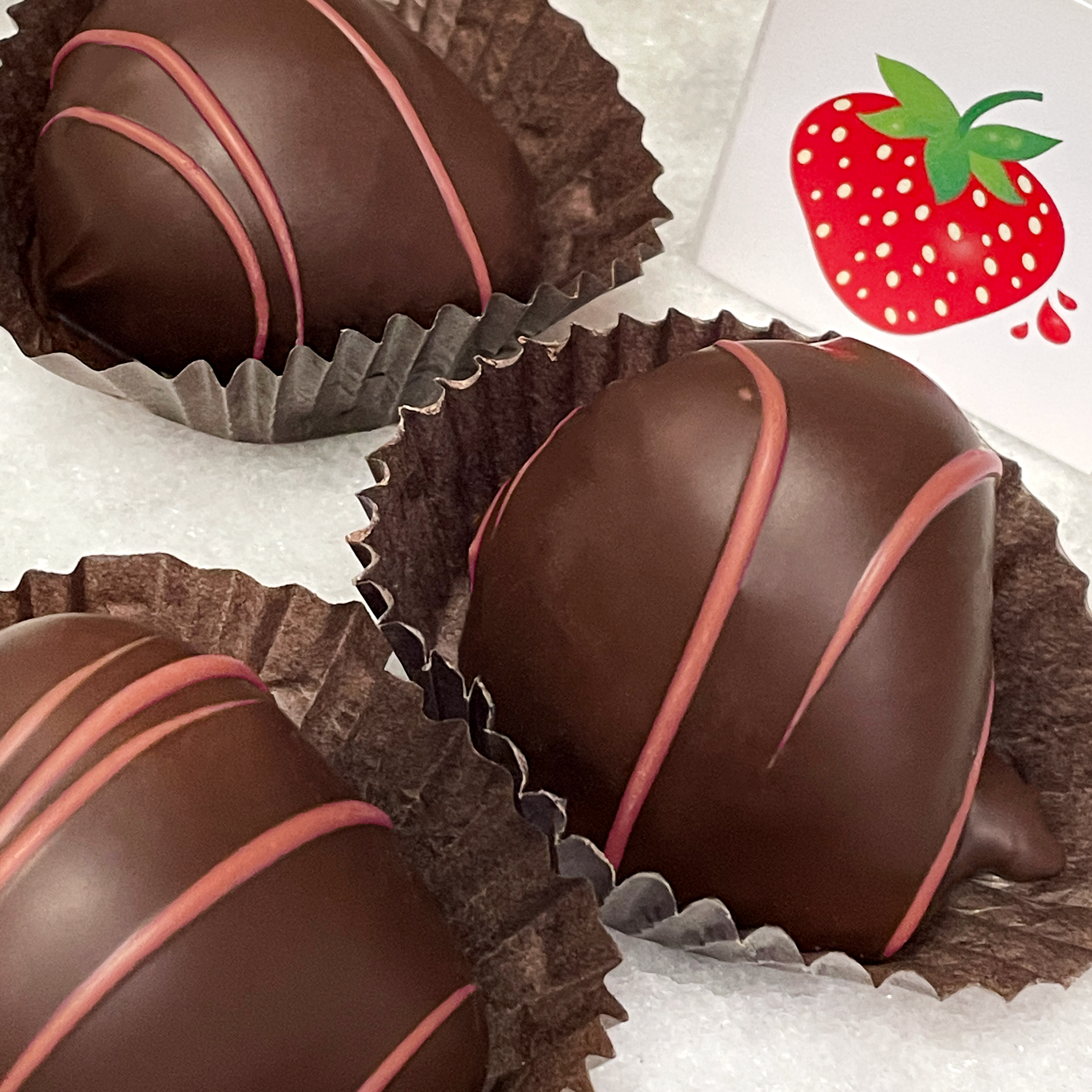 dark chocolate covered strawberries with ruby chocolate string