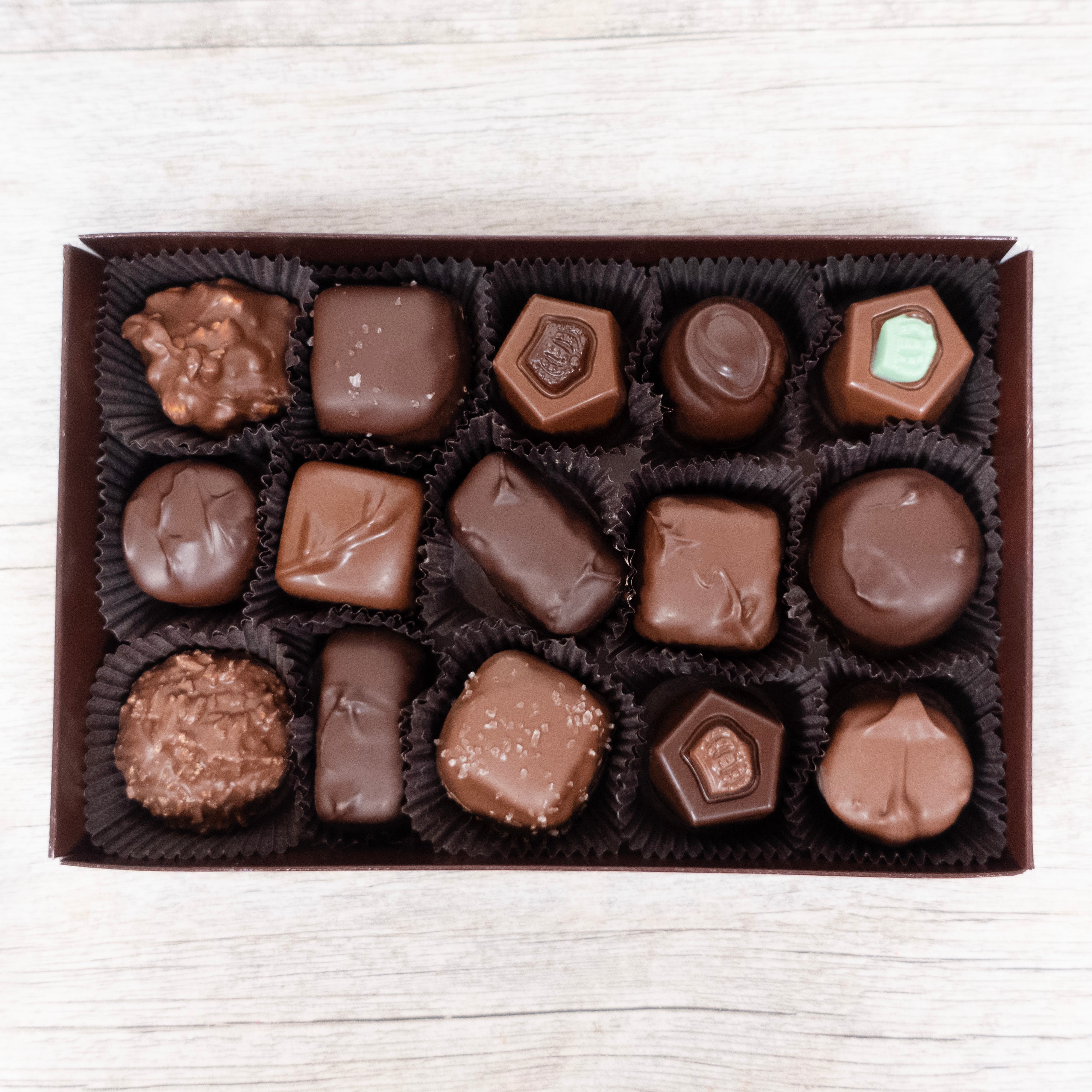 Closer detail shot of Assorted Half Pound Box of Sugar Free Chocolates from Lore's Chocolates in Philadelphia. The box contains a variety 15 Sugar Free Chocolates in both milk and dark chocolates.
