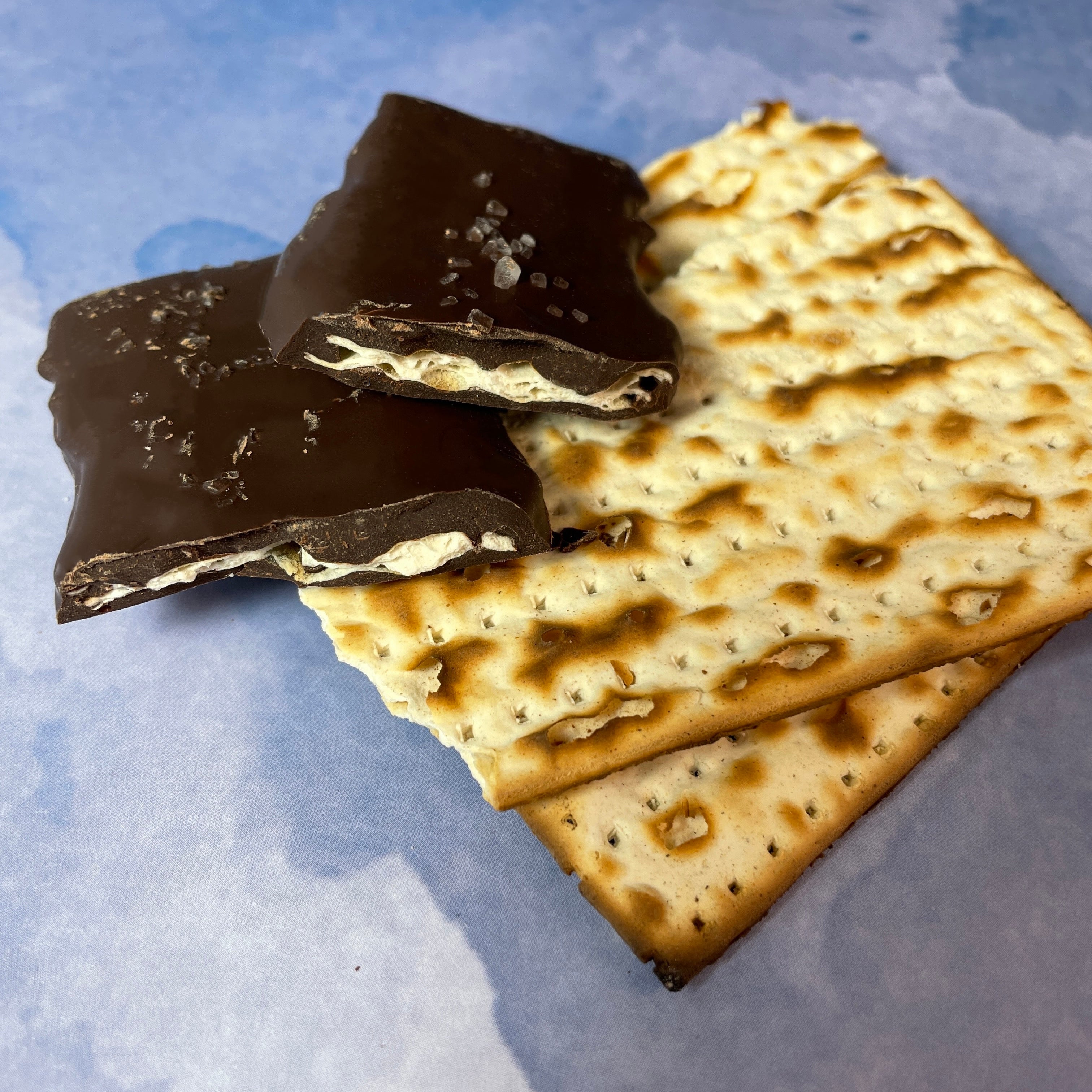 close up matzoh plain and chocolate-covered with flaky sea salt