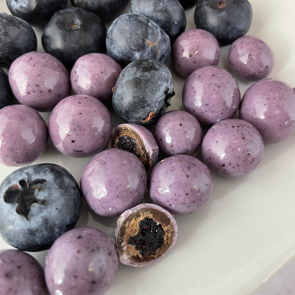 Lavender dried blueberries, covered in dark chocolate and a lavender white chocolate, surrounded with fresh blueberries for aesthetic