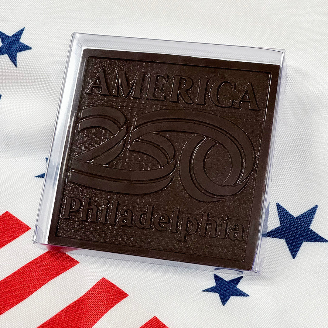 Chocolate bar with 'America 250 Philadelphia' text on a flag background