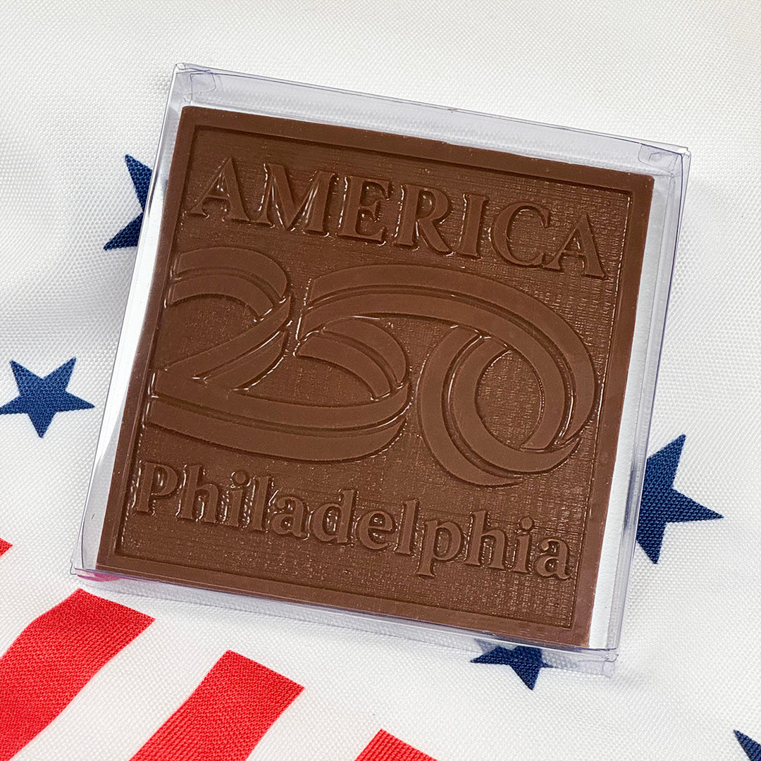 Chocolate bar with 'America 250 Philadelphia' text on a flag background