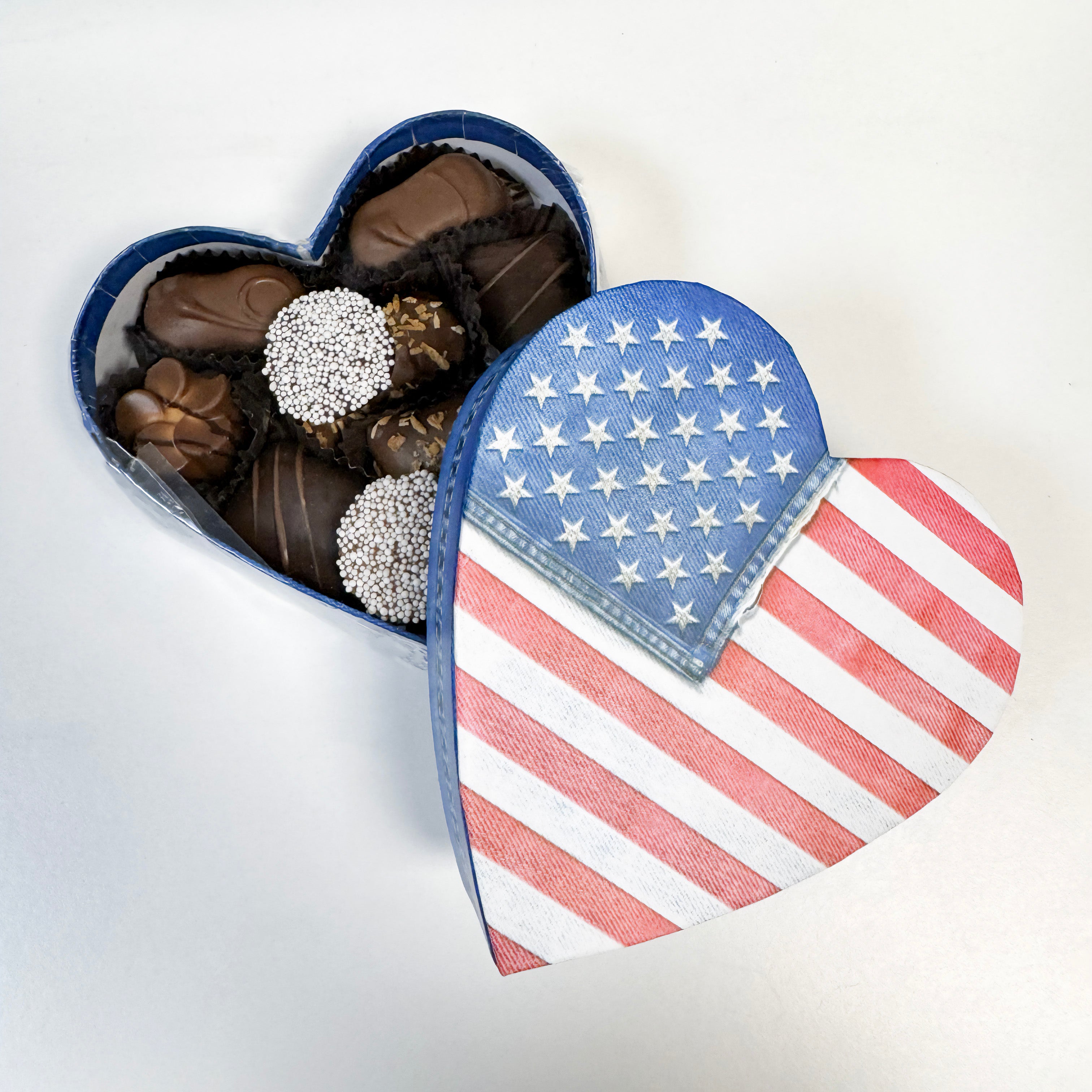 Heart-shaped box of chocolates with a denim American flag design on a white background - filled with Philadelphia chocolates made by Lore's Chocolates