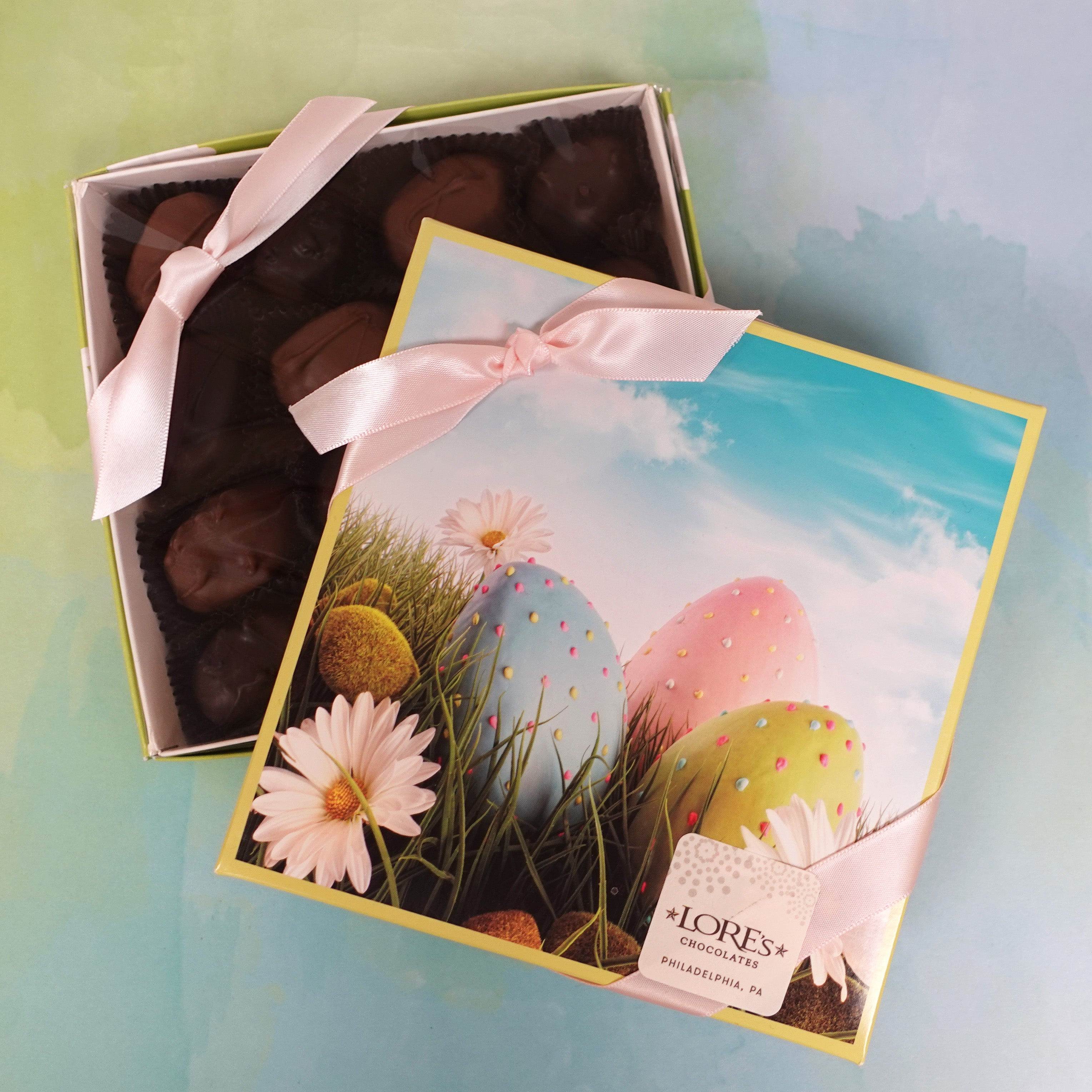 square box of chocolates with Easter Eggs and blue skies behind