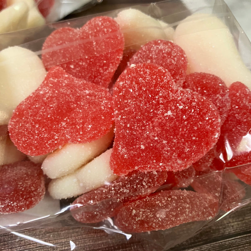 close up of the sugar on red and white gummy hearts