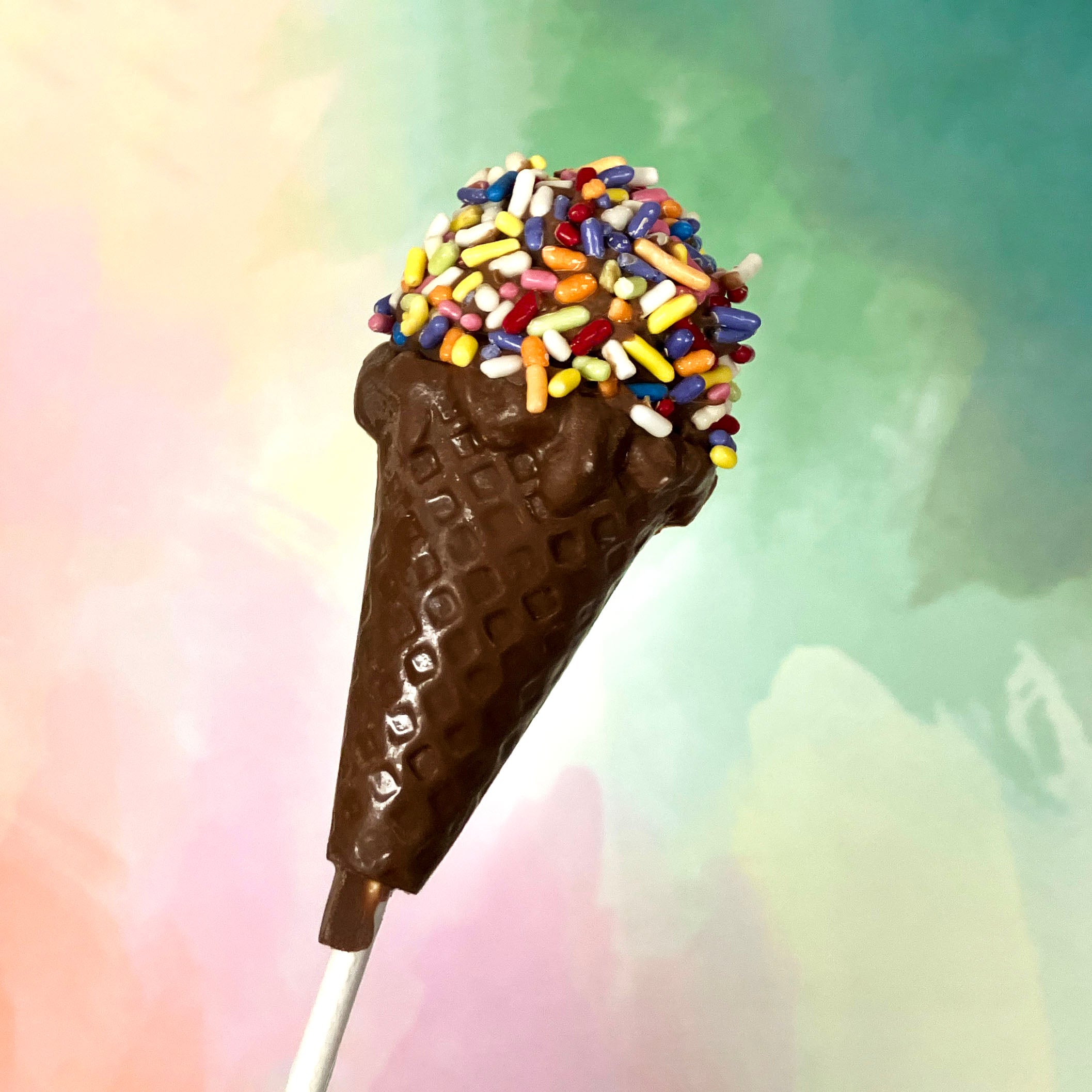 Lore's Milk chocolate lollipop shaped like an ice cream cone with sprinkles aks jimmies.