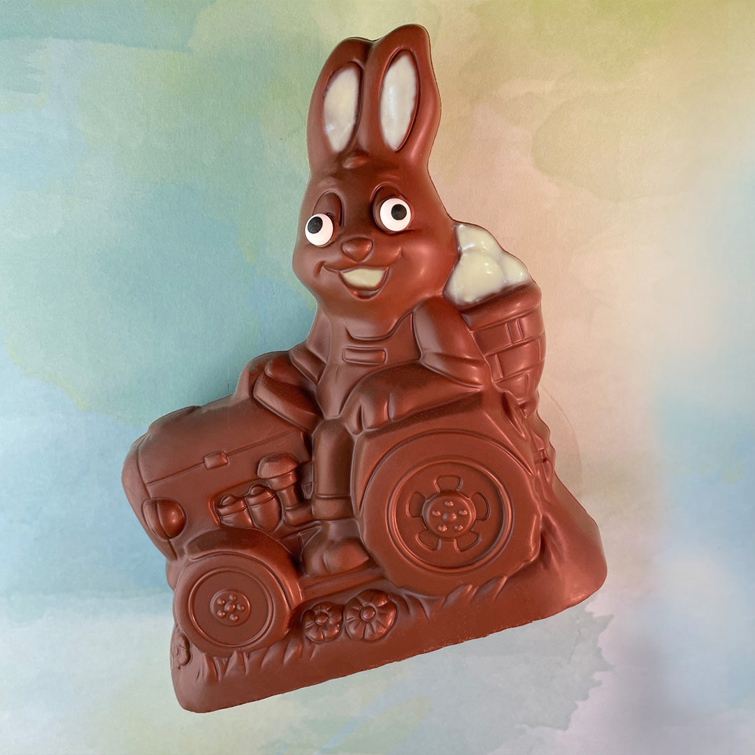 Milk Chocolate Easter bunny on a tractor with a colorful background