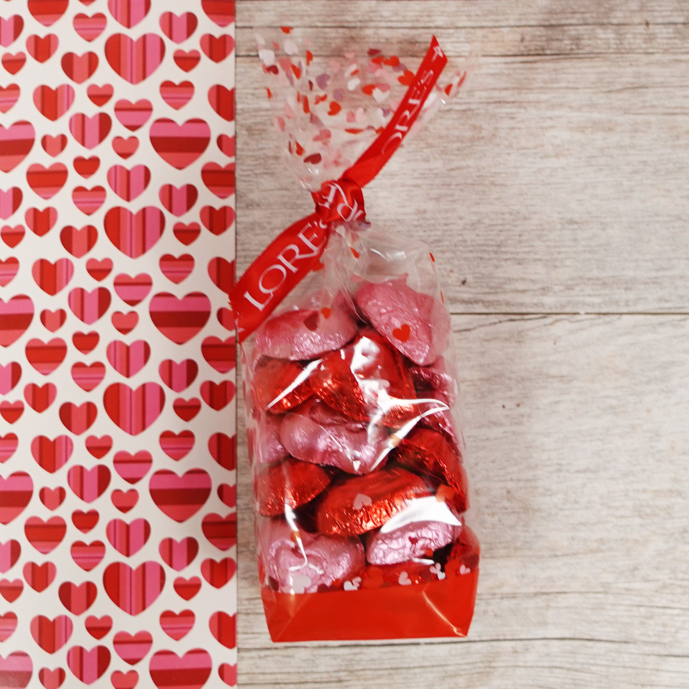 red and pink foiled milk chocolate hearts in cello valentine's day bag with Lore's Chocolates Red Ribbon