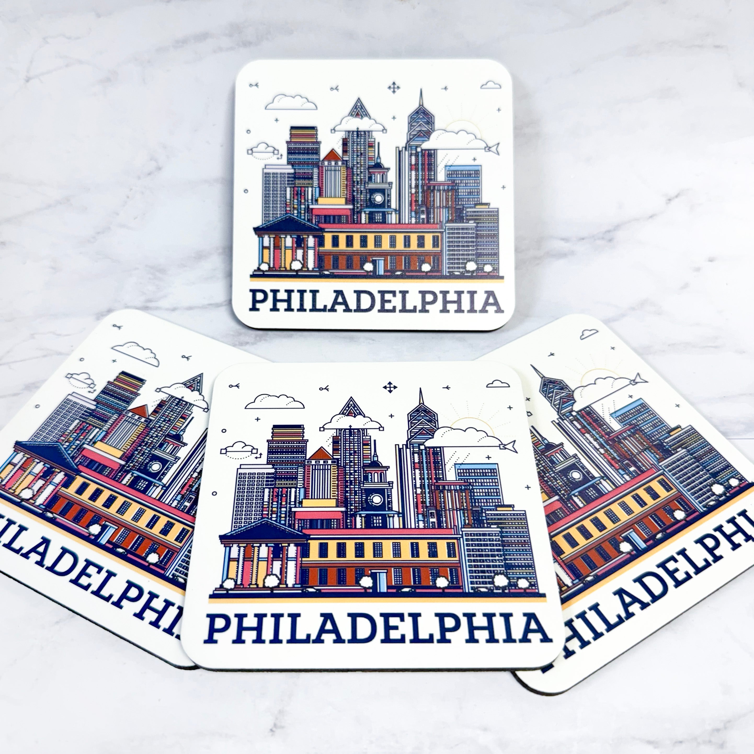 Coasters with Philadelphia skyline design on a marble surface