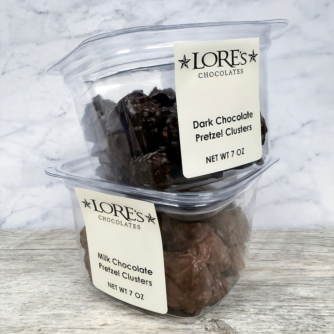 Container of Lore's Chocolates Dark Chocolate Pretzel Clusters on a marble surface