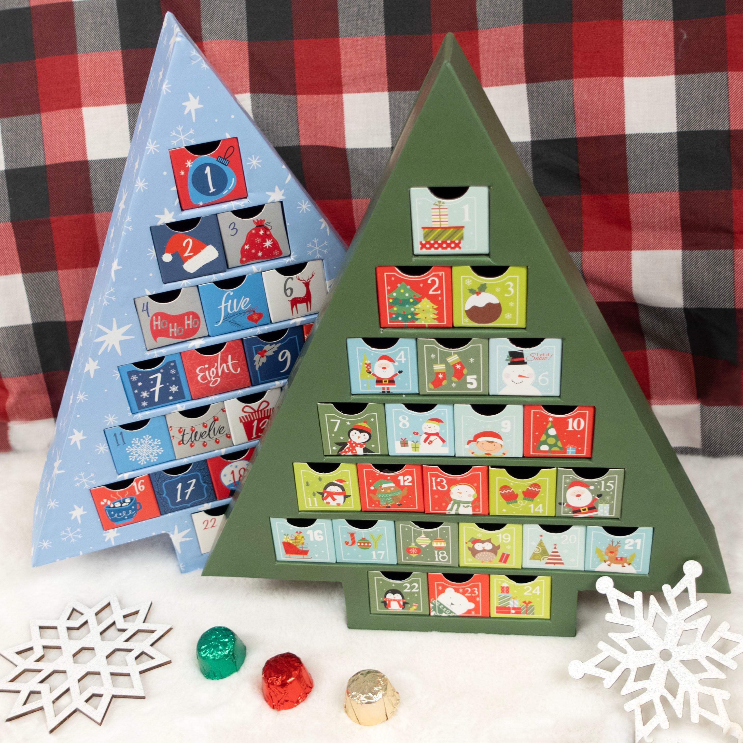Two triangular advent calendars, one blue and one green, on a checkered fabric background.