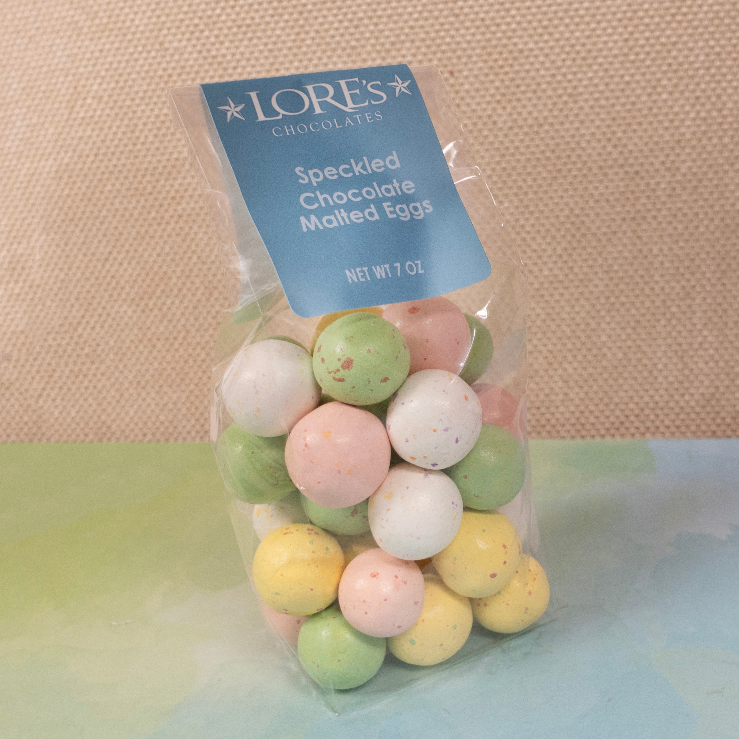 bagged speckled easter egg malt balls - label reads "Lore's Chocolates, Speckled Chocolate Malted Eggs, Net Wt 7 oz" 