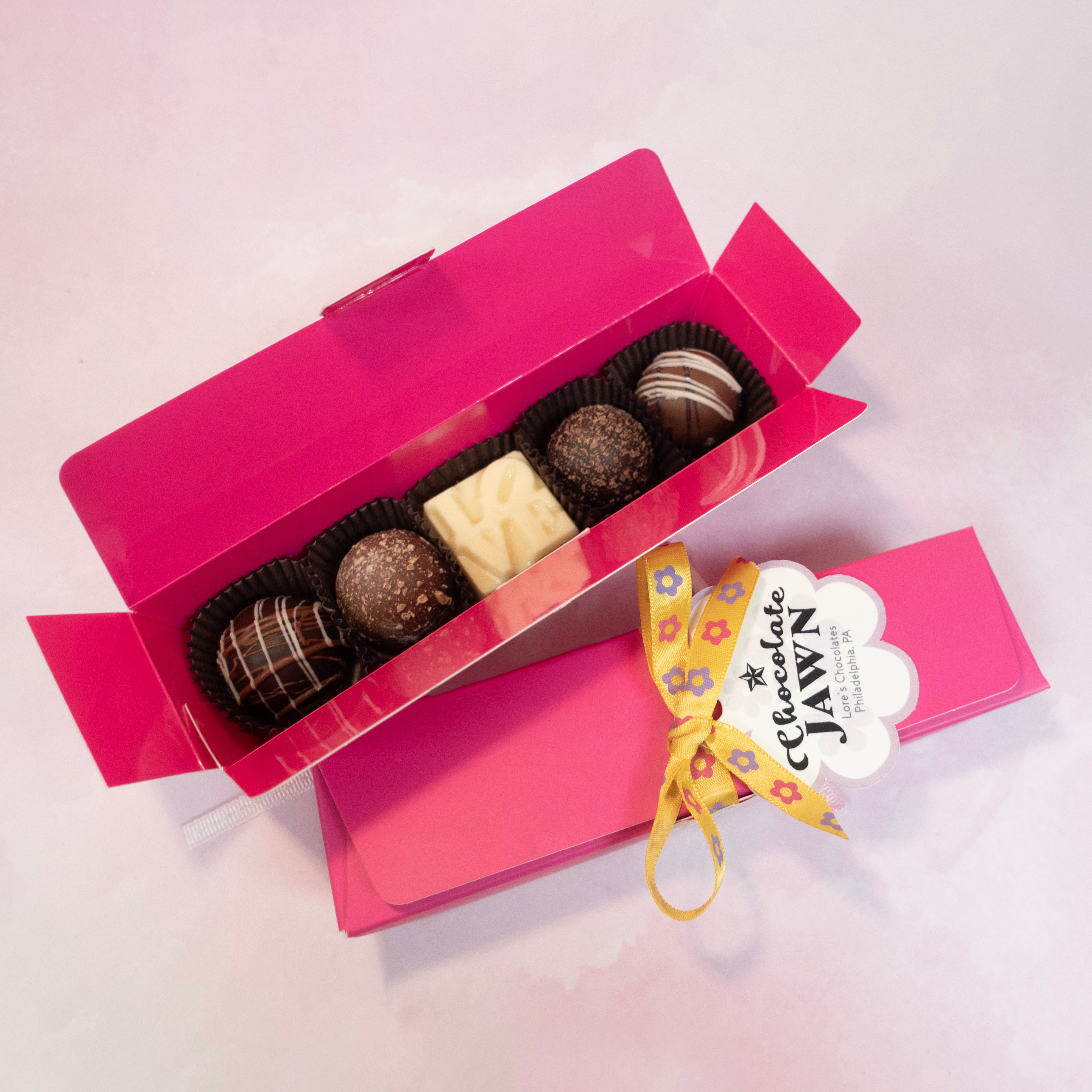 Chocolate Jawn, rectangular box in hot pink color - contents include a mini white LOVE statue chocolate, and artisan truffles 