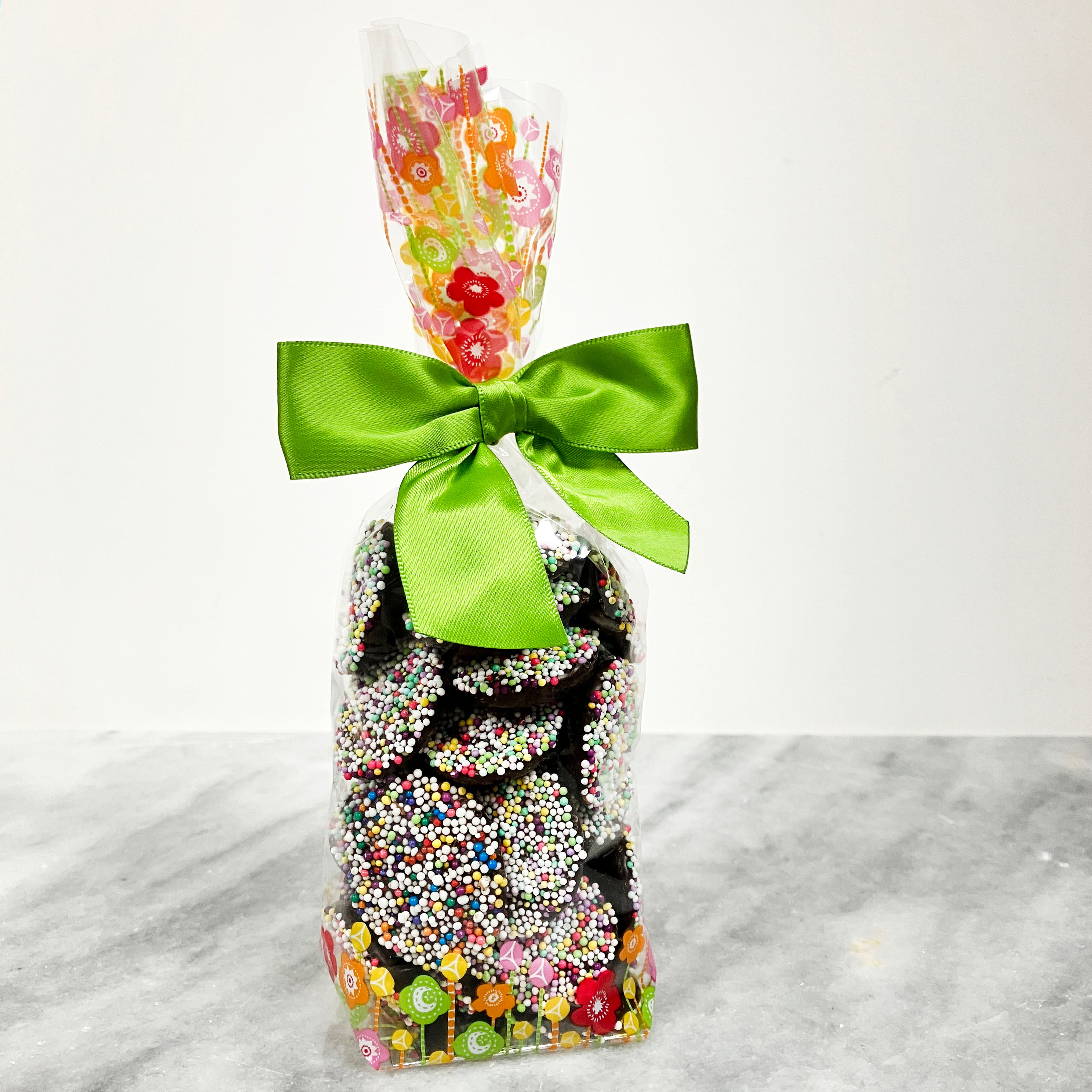 Dark Chocolate nonpareils with springtime colors and a decorative spring flowers bag
