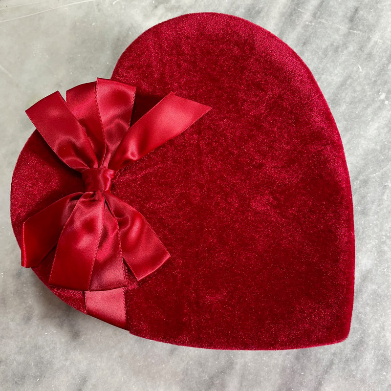 red velvet heart box decorated with a red satin bow-chocolate selection is assorted milk and dark