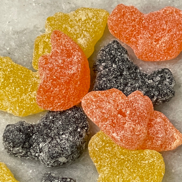 Sour gummy candies.  Bats, cats, and moons in Halloween colors: orange, black, and yellow.