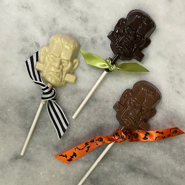 3 Chocolate lollipops shaped like Frankenstein's monster - white chocolate, dark chocolate, and milk chocolate
