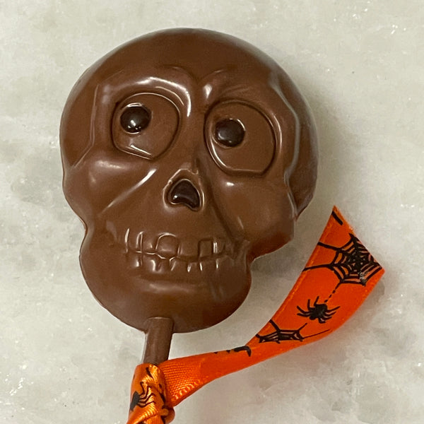 Halloween Milk Chocolate Skull lollipop with a pop of dark chocolate for the eyes and nose Made in Philadelphia