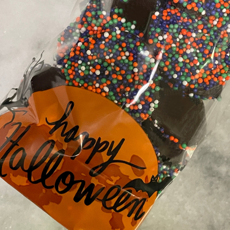 Dark chocolate drops with fall candy non-Pareils seeds (halloween colors orange, purple, white, and green)